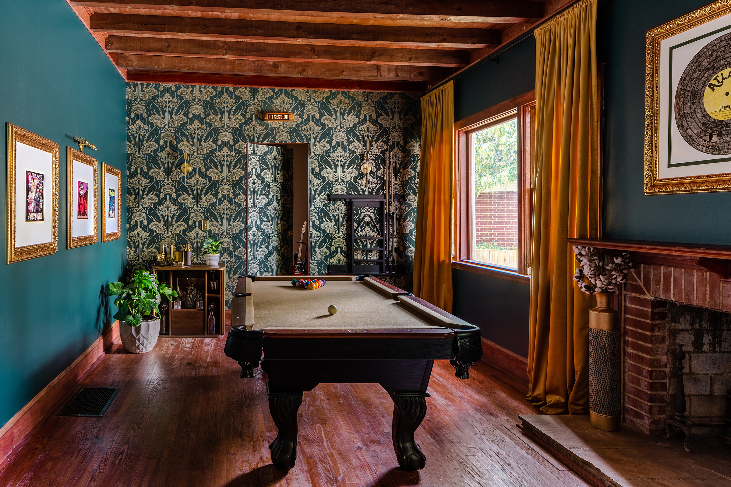Billiards room of The Dungeon House with exposed wooden beams, a pool table and jewel blue toned walls and wallpaper