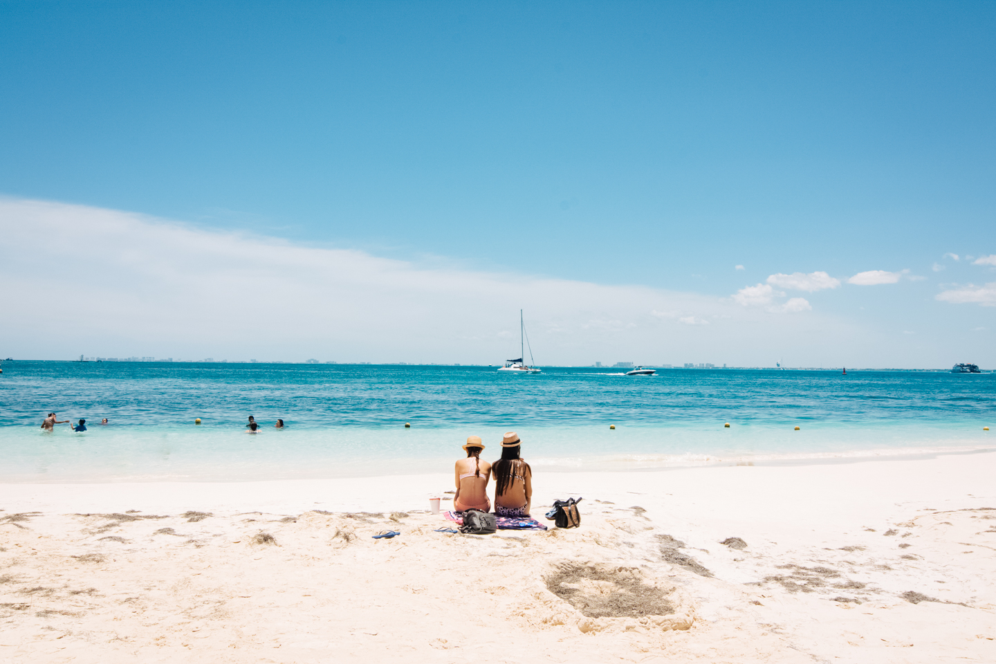 A couple seated in a beach of The Caribbean