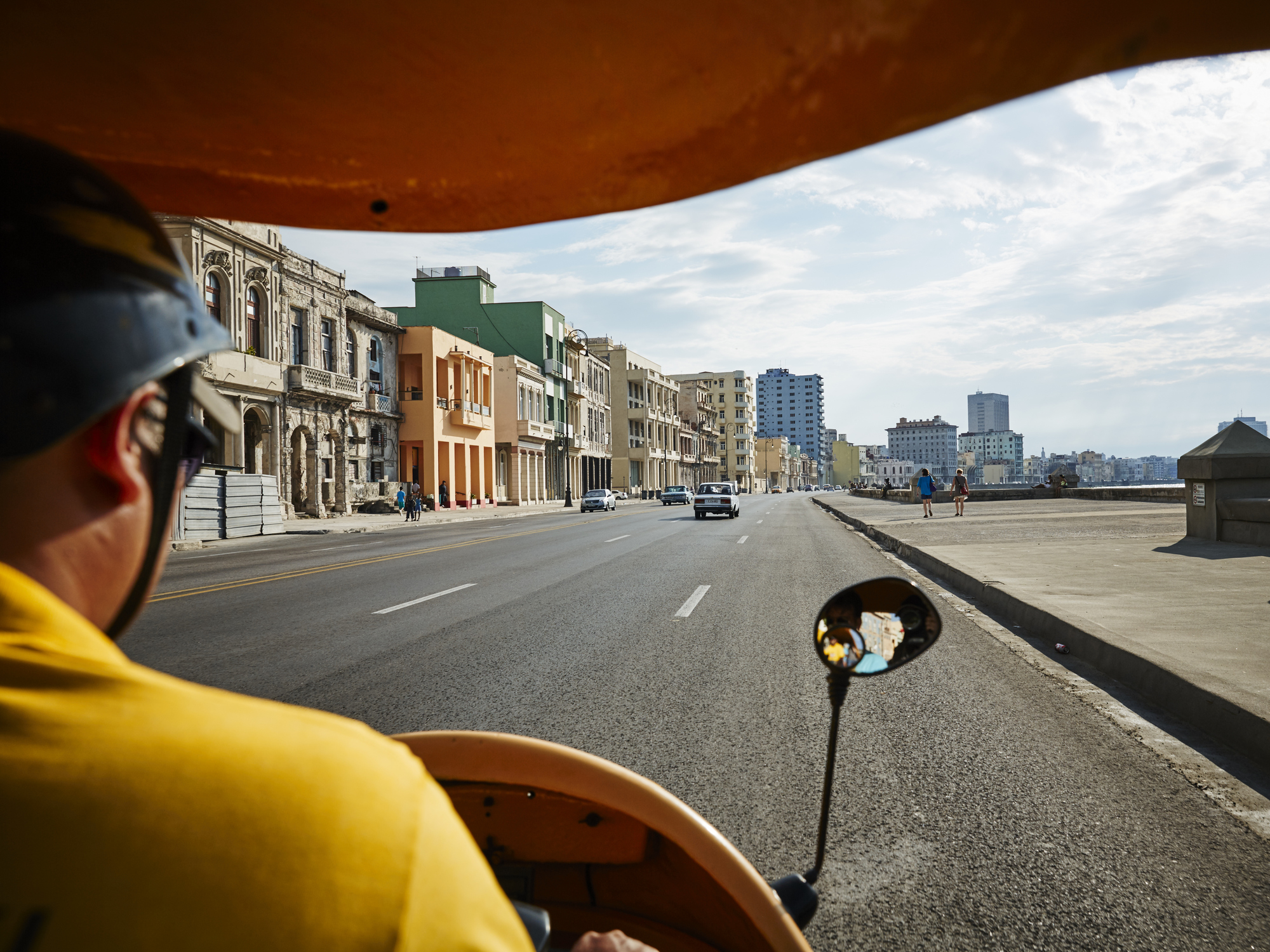 Back view of a Man driving a moto-taxi in Havana Cuba
