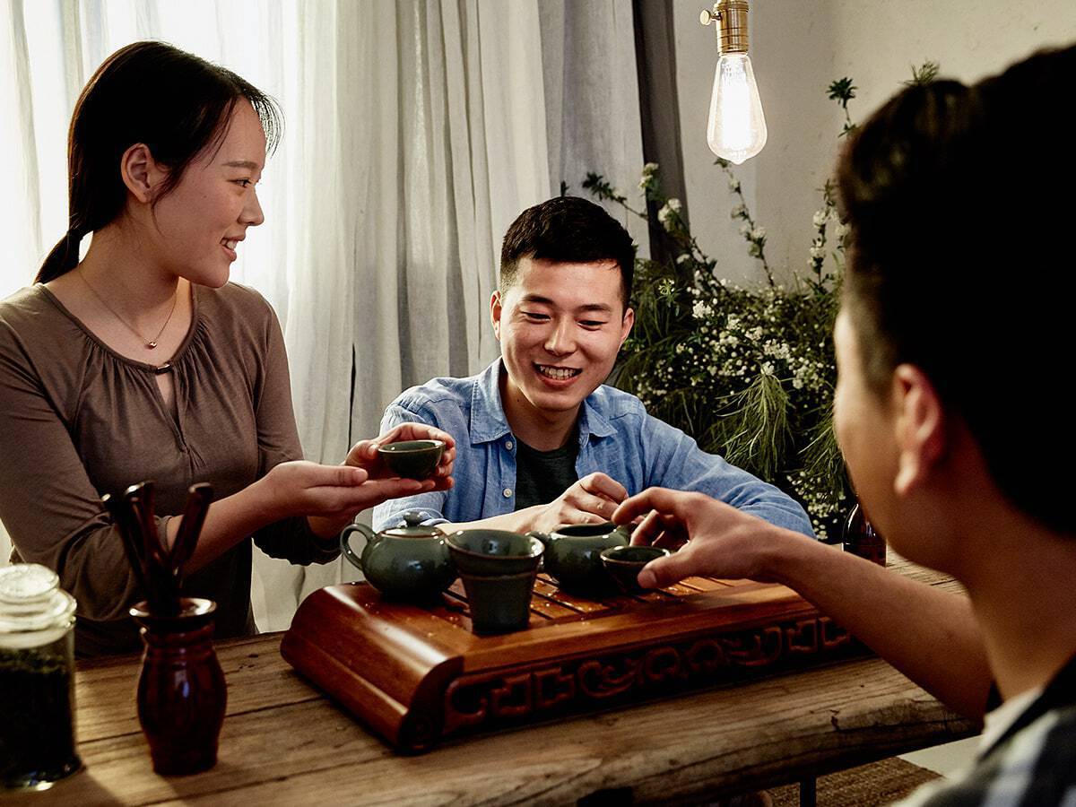 Airbnb hosts and guests sharing tea