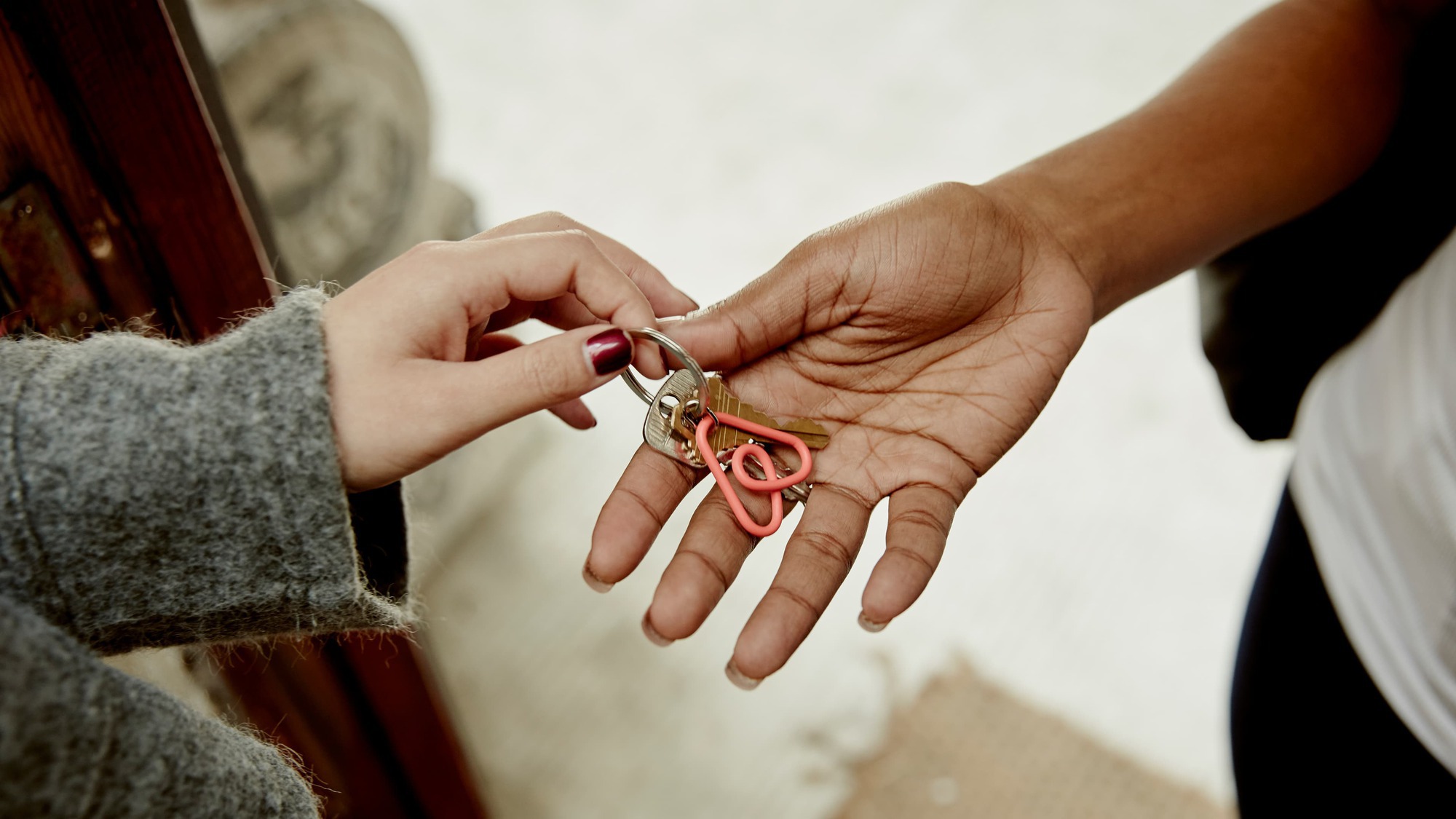 Host on Airbnb handing a key to their guest