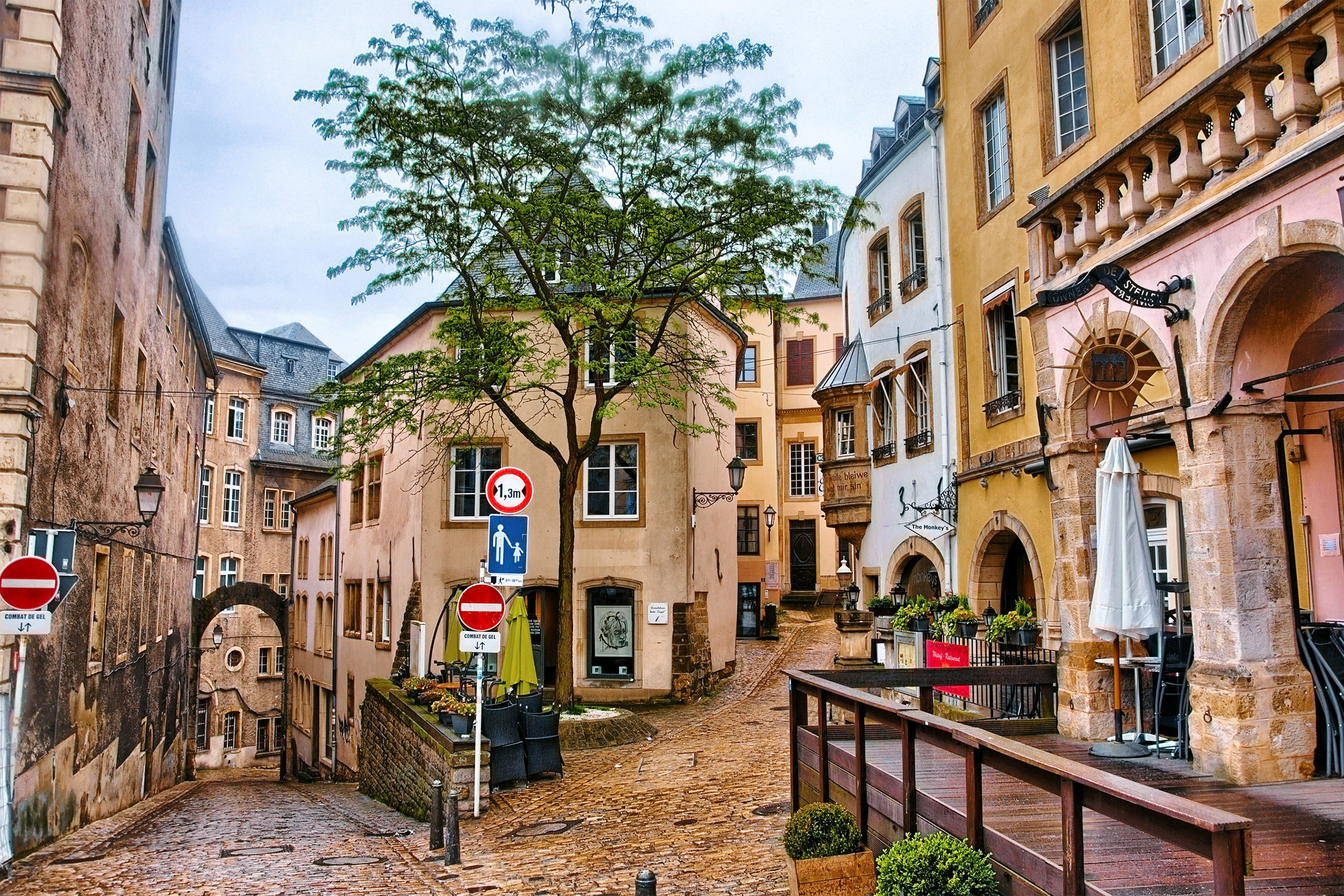 Narrow medieval street with cafes in Luxembourg city, Luxembourg.