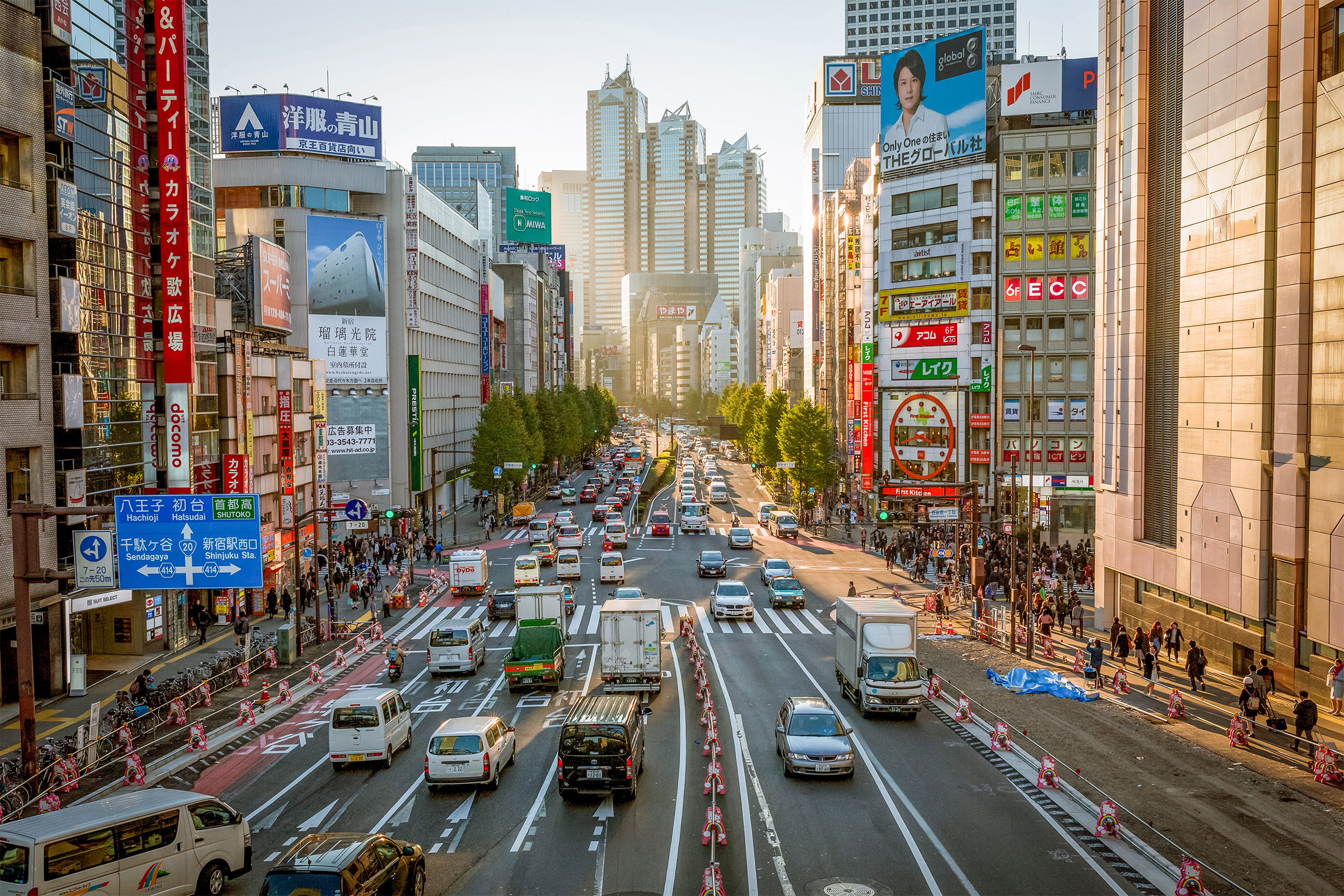 A busy city street surrounded by skyscrapers in Tokyo, Japan.