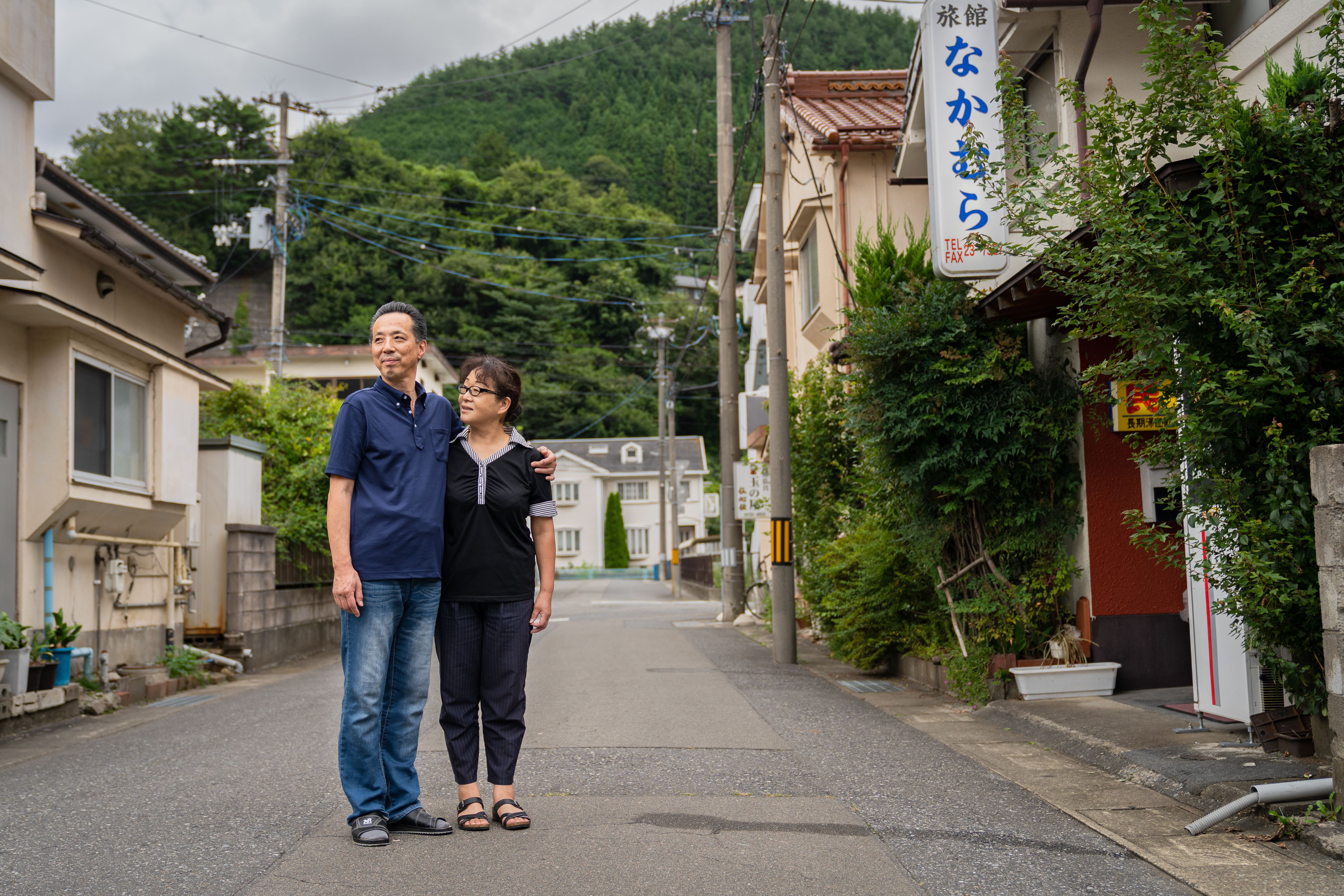 Two Airbnb hosts stand in the middle of the road in Kamaishi, Japan.