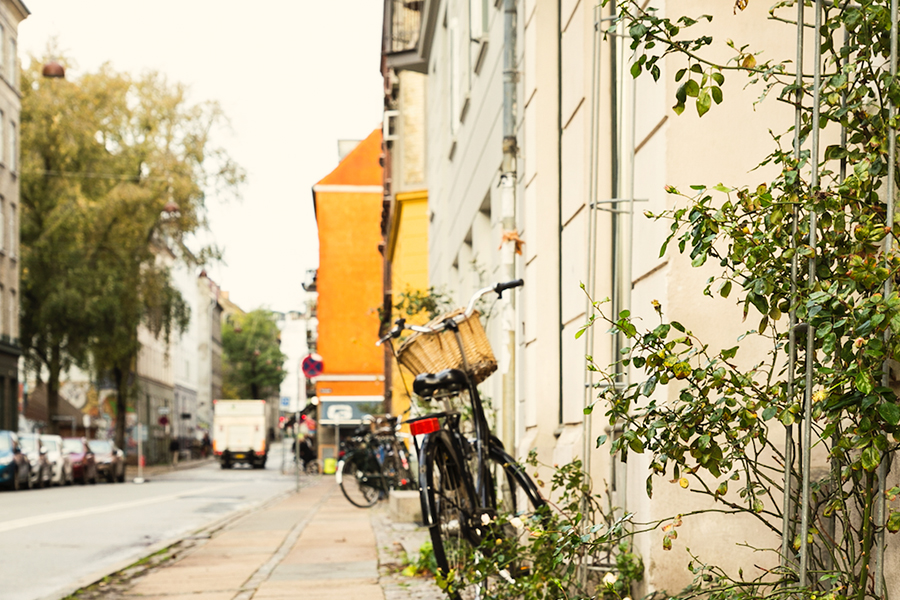 A bike is parked on a sidewalk in Copenhagen.