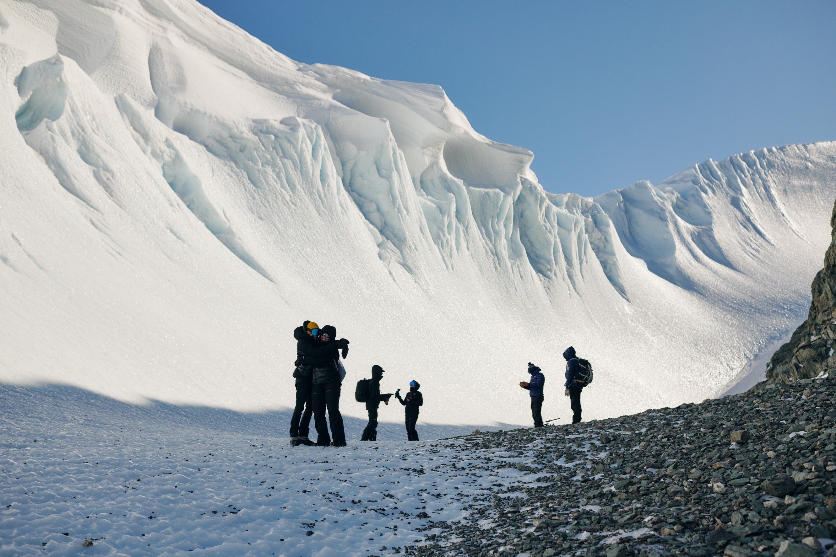 Citizen scientists celebrate at the base of the Charles Peak windscoop in Antarctica