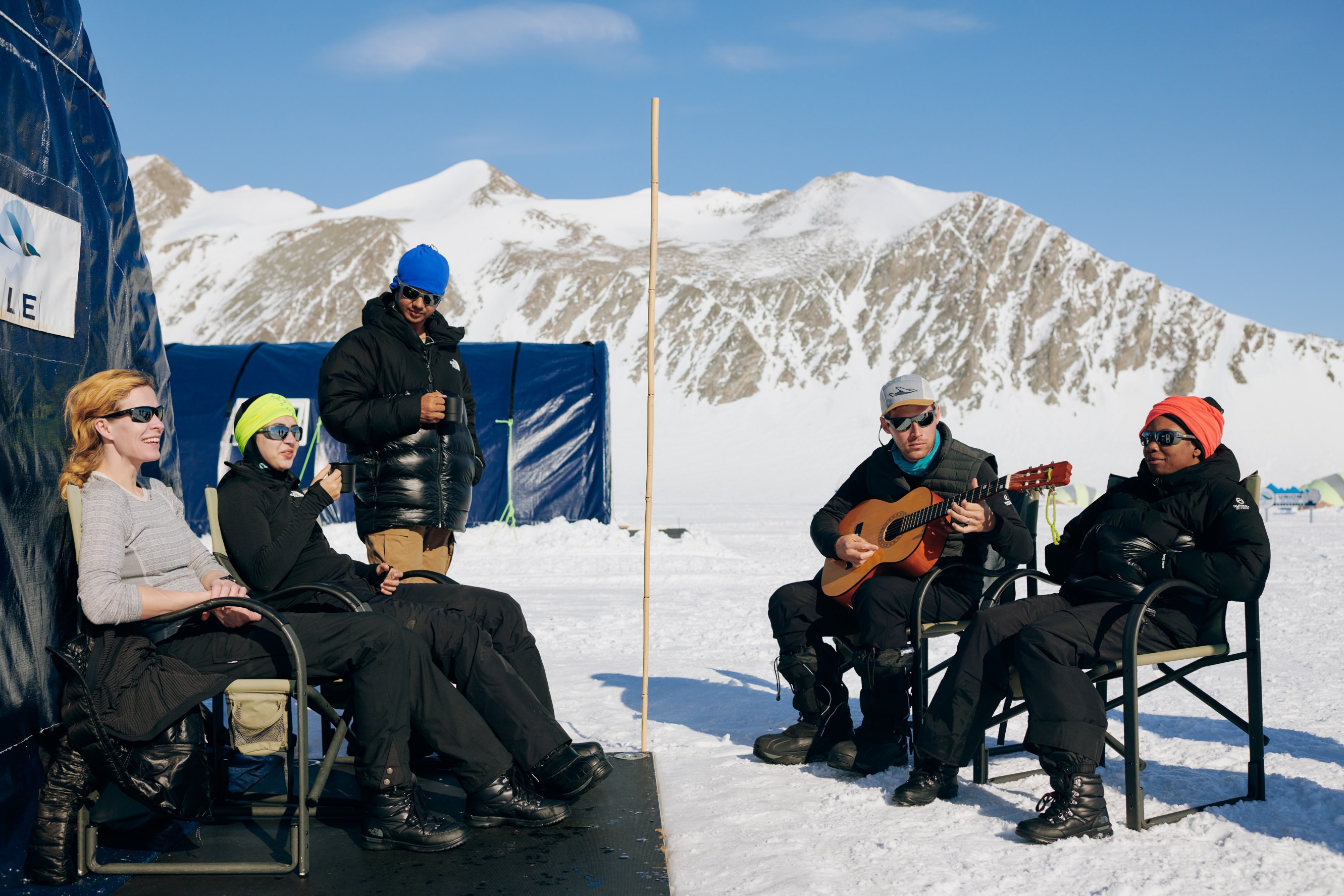 Citizen scientists hangout and play music during down time in Union Glacier camp