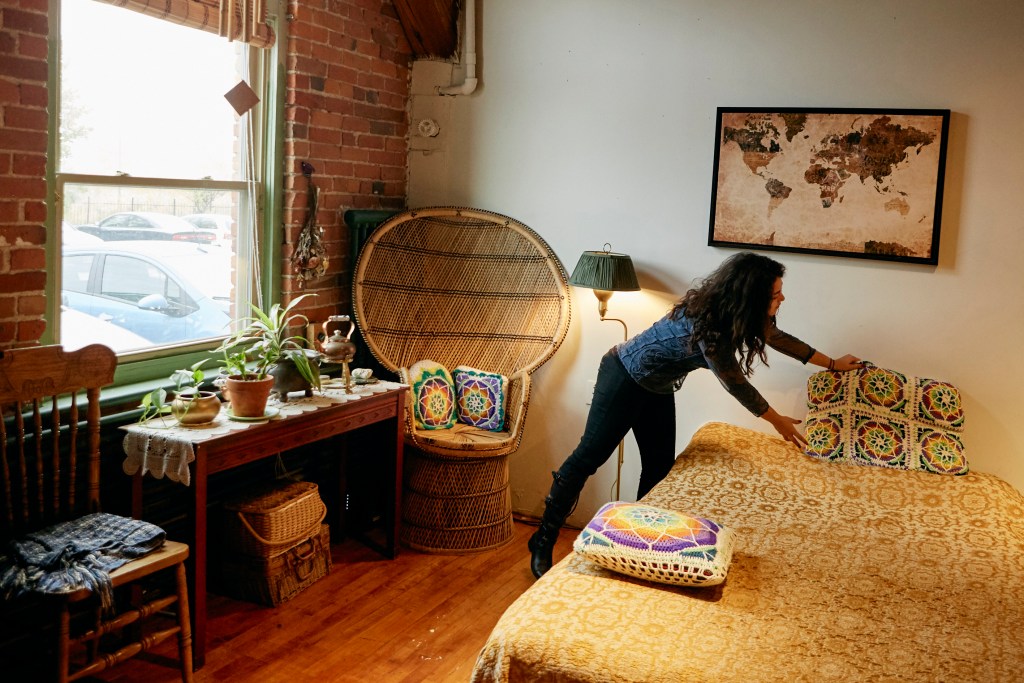 A host gets her comfortable and cozy listing ready before the arrival of her next guests. 