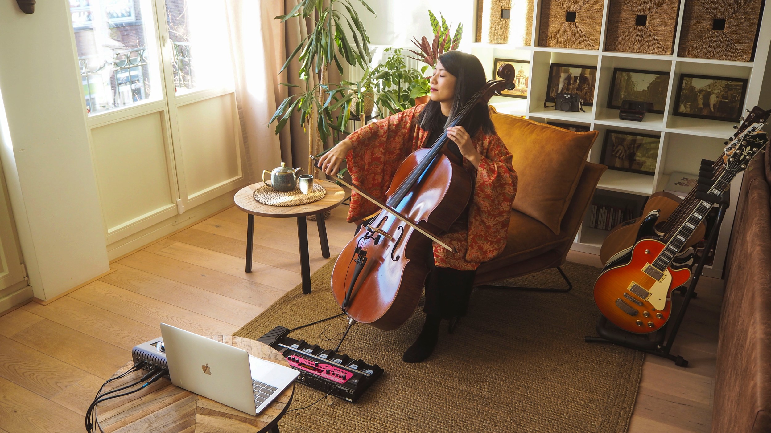 A musician plays her cello to an online audience using Airbnb Online Experiences.