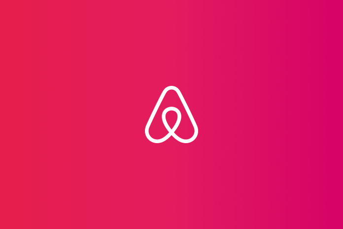 Airbnb logo placed on deep pink gradient colored background