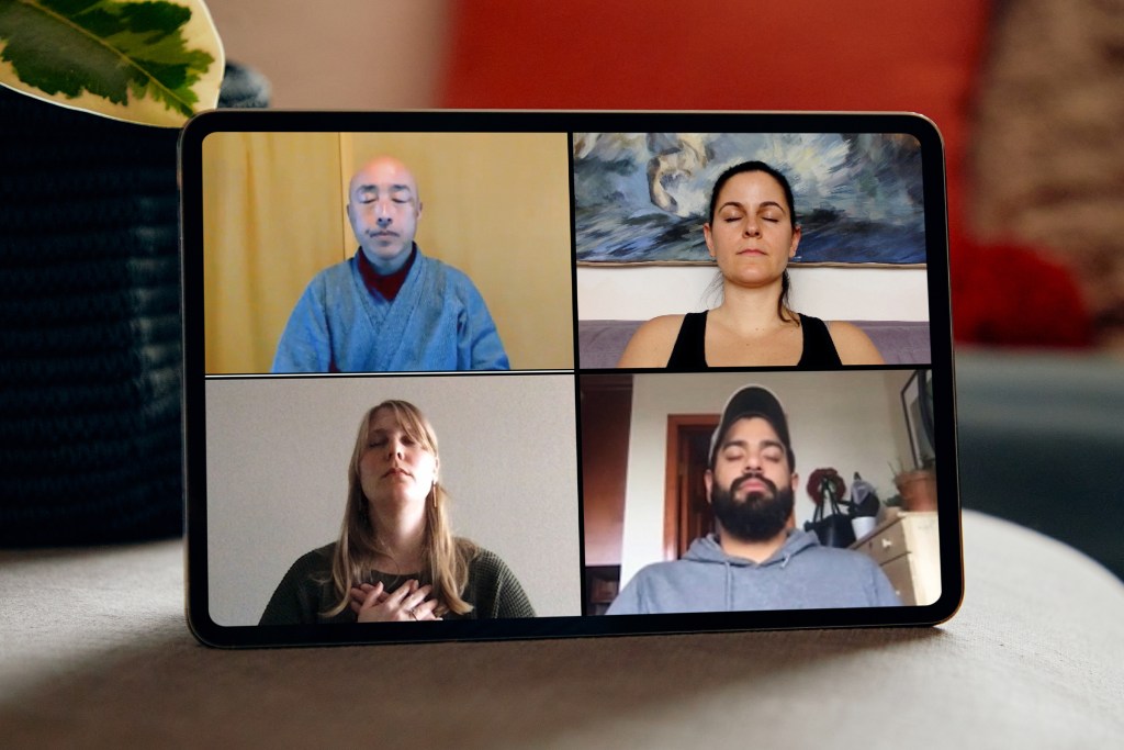 Guests in a meditation Airbnb Online Experience are seen closing their eyes on an iPad.