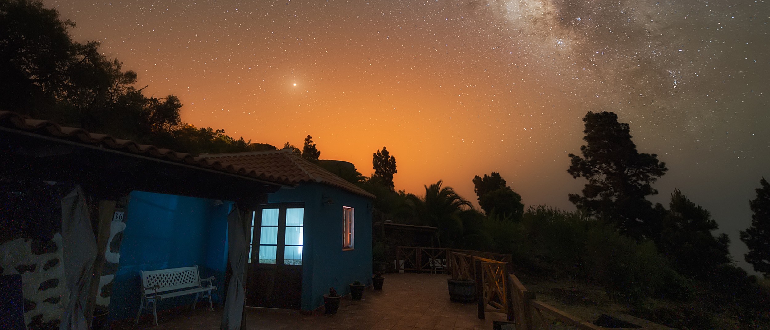 Stars and mars are visible in the night sky over an Airbnb listing.