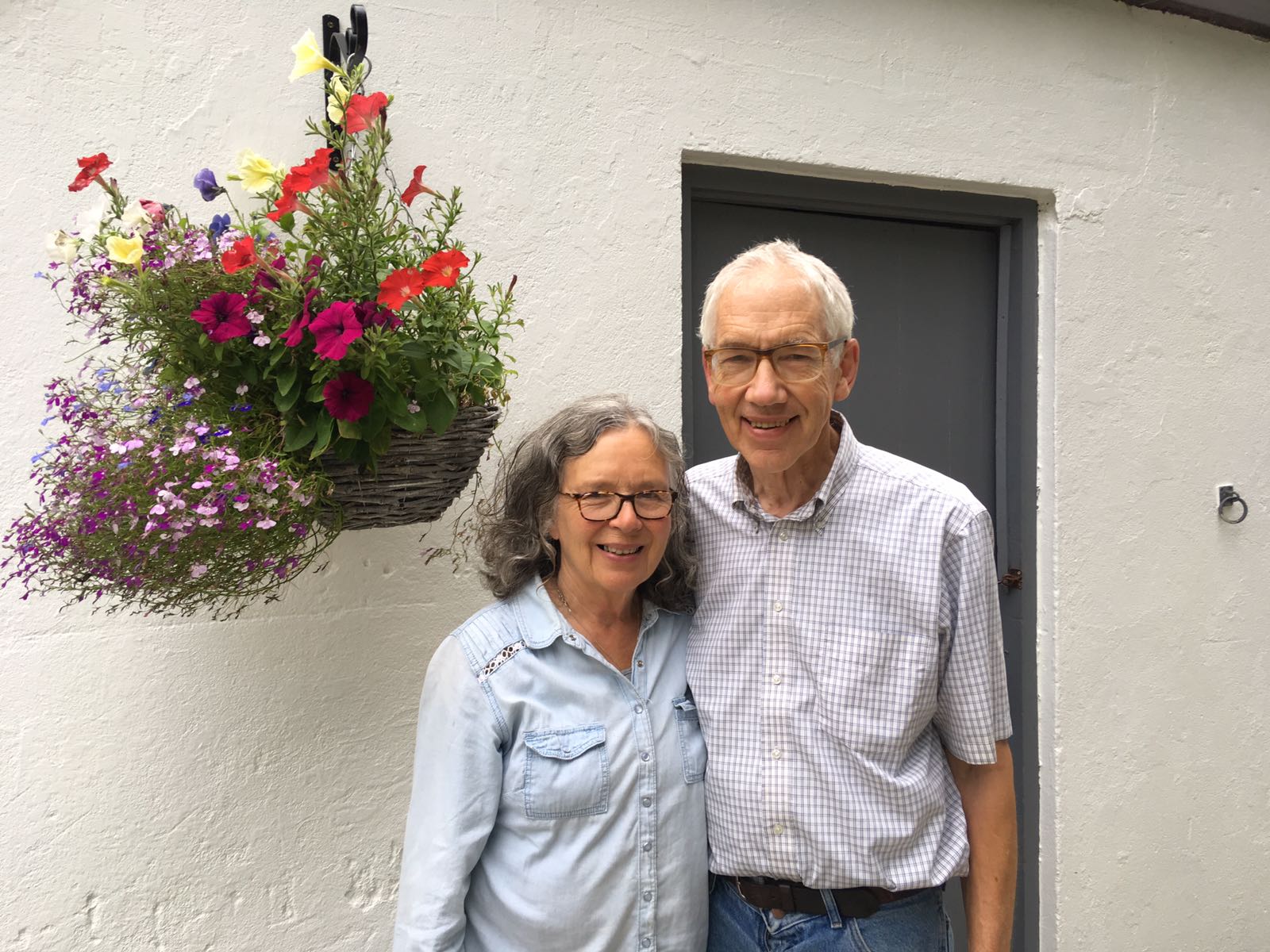 Superhosts, Alex and Renie, in front of their farmhouse in Wales