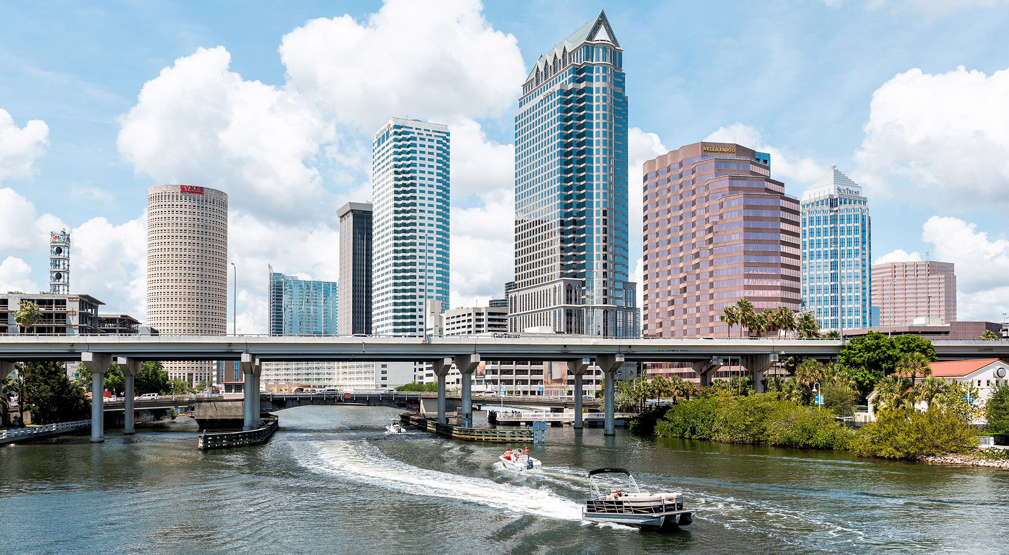 Tampa's skyline is pictured, with a boat in the water in the foreground.