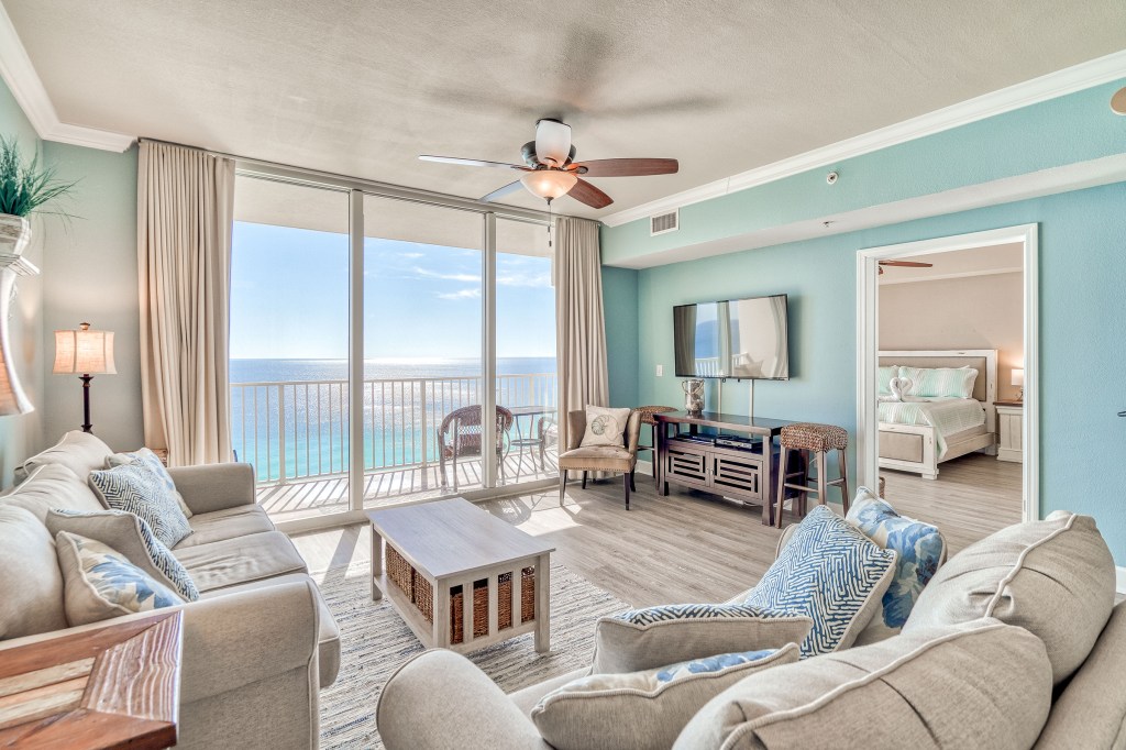 Living room and balcony photo of the Tidewater Beach Front stay in Panama City Beach, Florida