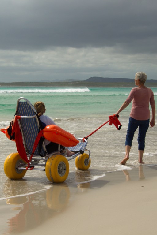 A guest taking a beach excursion in a specialized beach wheelchair.