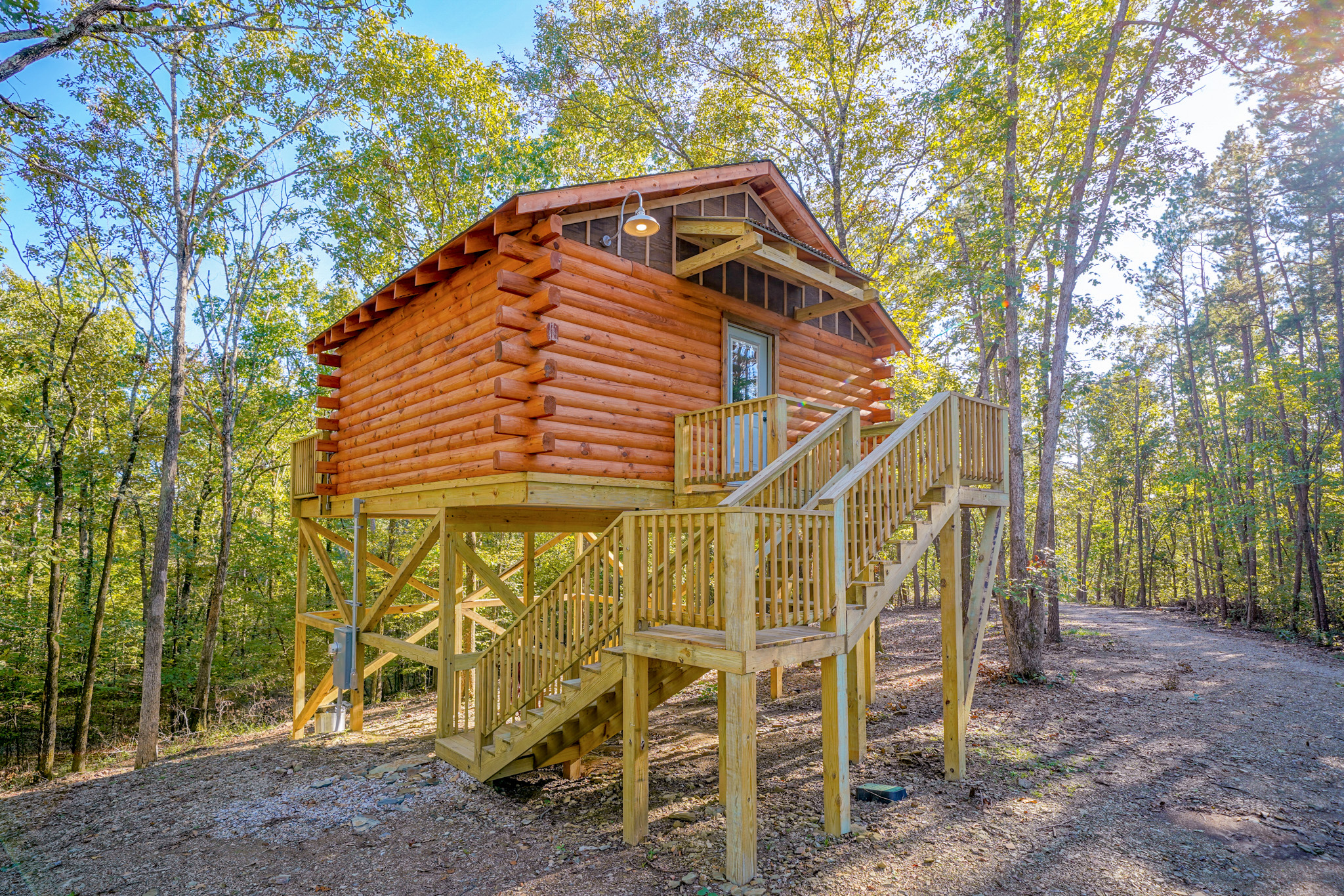 Traditional log cabin treehouse situated in the woods.