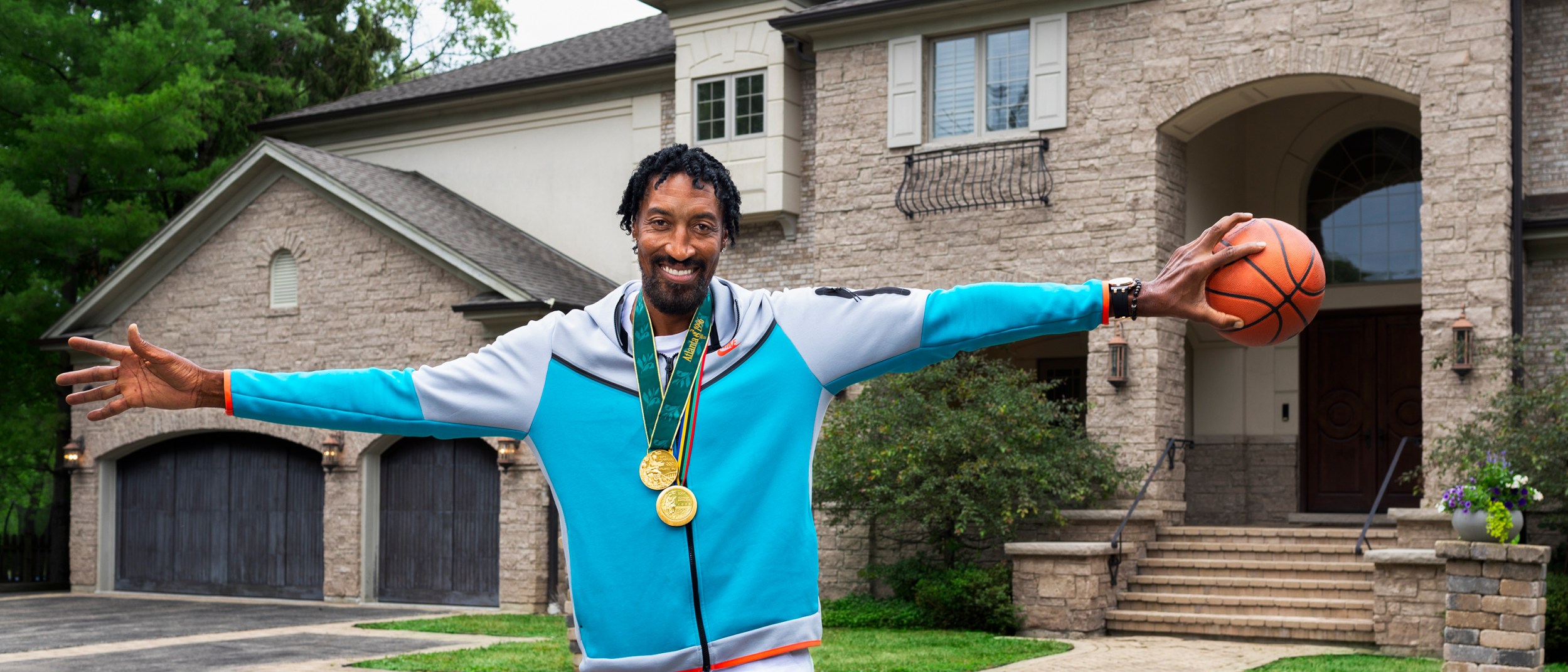 Scottie Pippen palms a basketball outside of his Chicago home that he is listing on Airbnb.