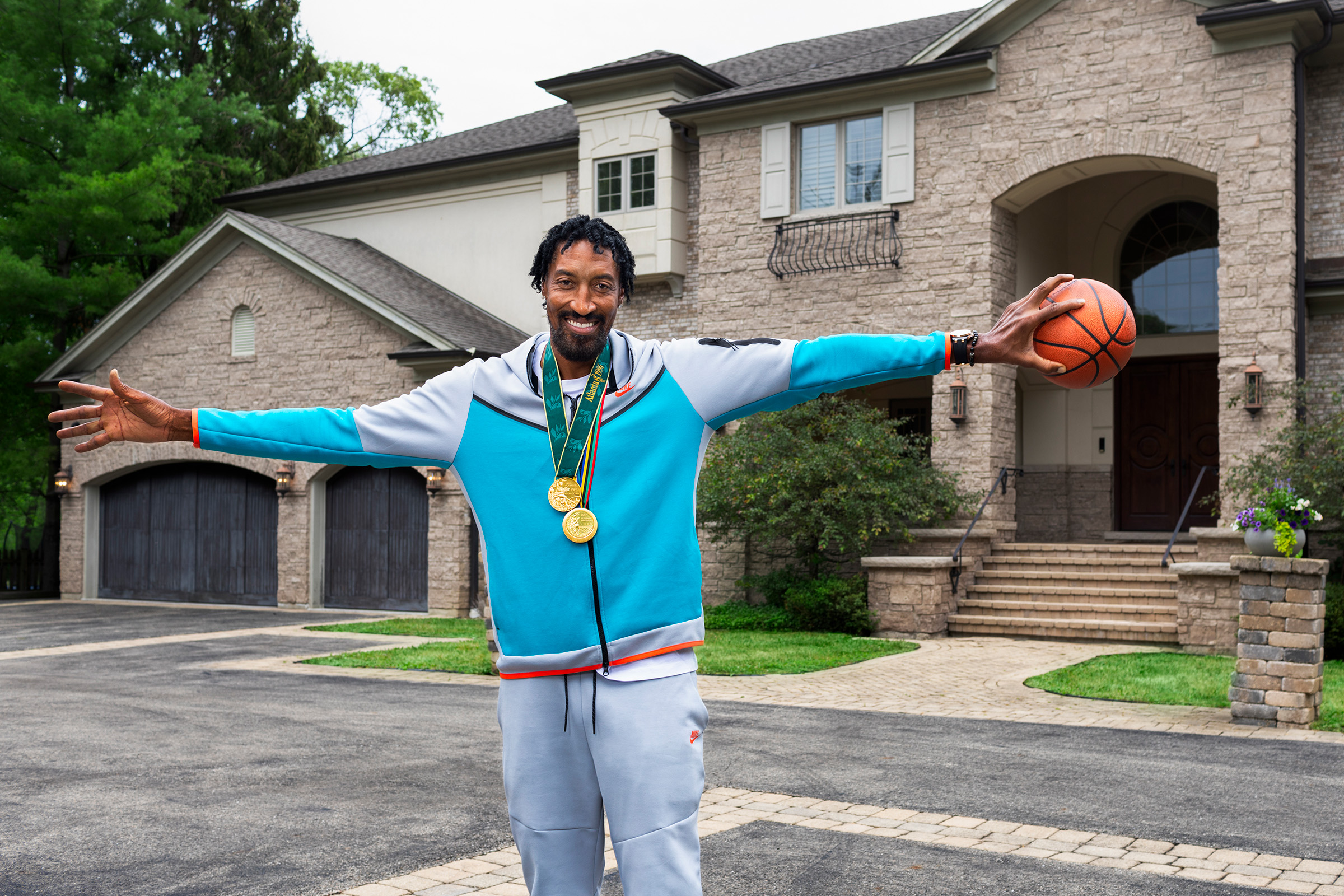 Scottie Pippen palms a ball outside of his Chicago home that he is listing on Airbnb.