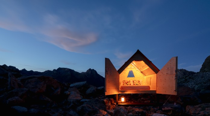 Starsbox in the evening with a dramatic nighttime landscape behind the glowing cabin.