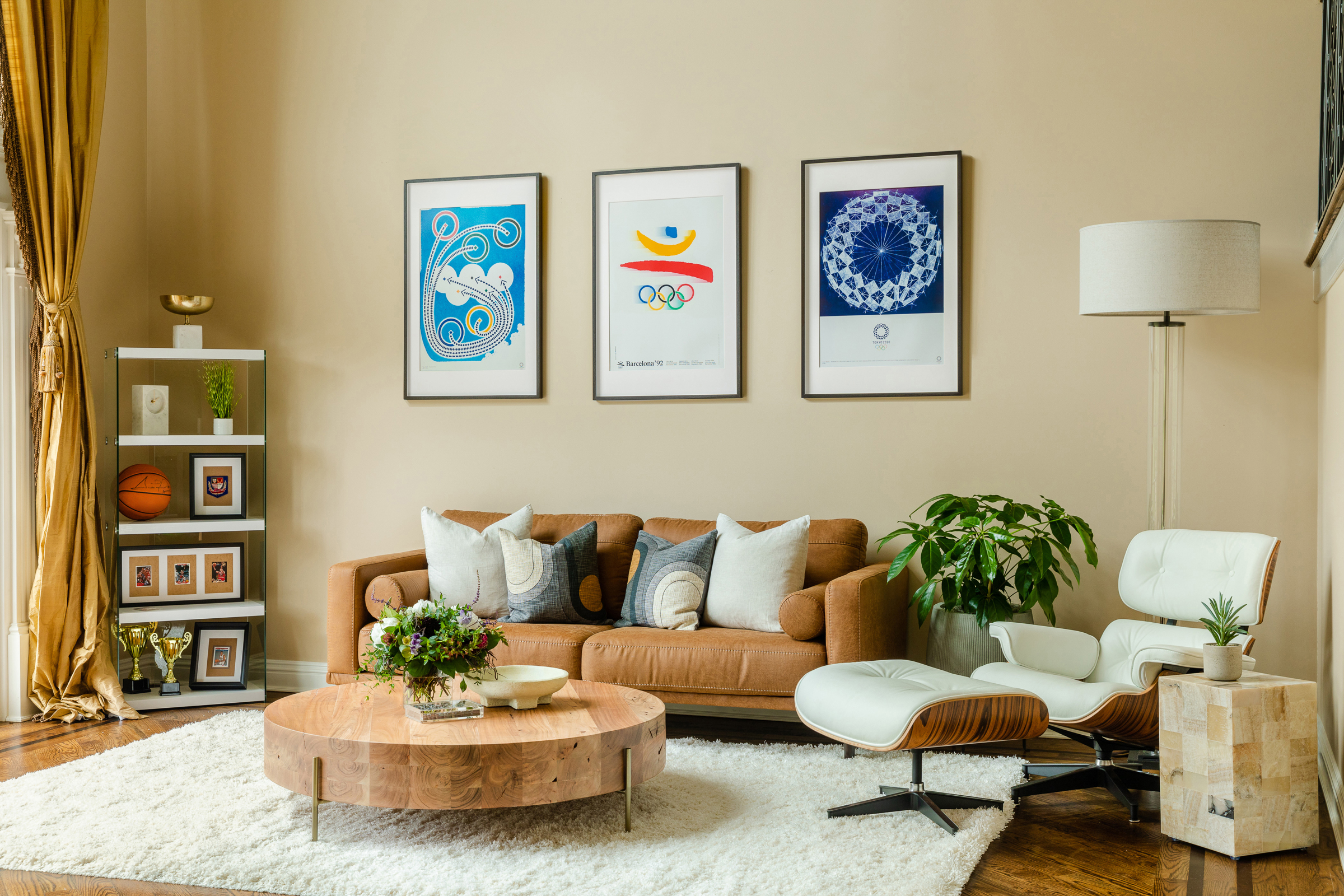 Living room with comfortable couch and nostalgic and current Olympic posters.