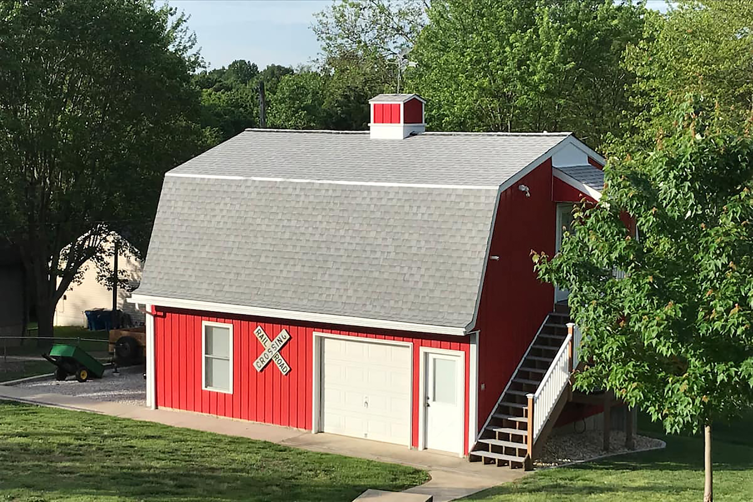 A red bar with a "Railroad crossing" sign hung next to the garage.