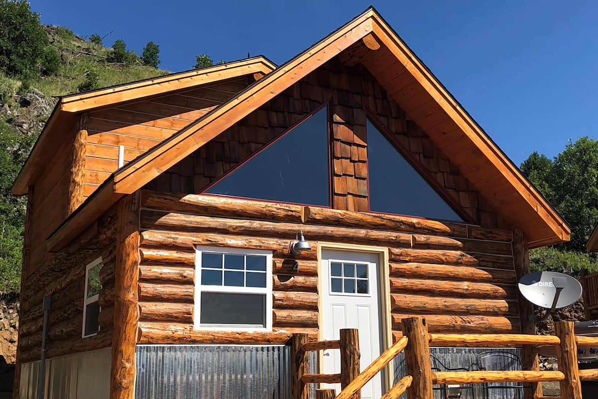 A large cabin with a white door and television satellite