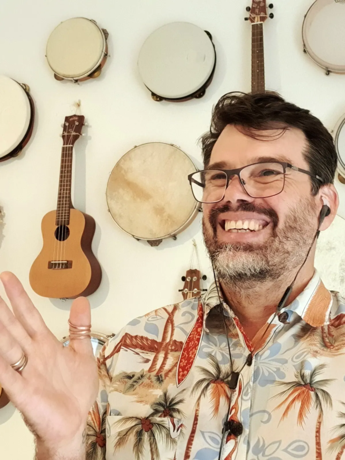 Man laughing at the camera and gesturing with one hand