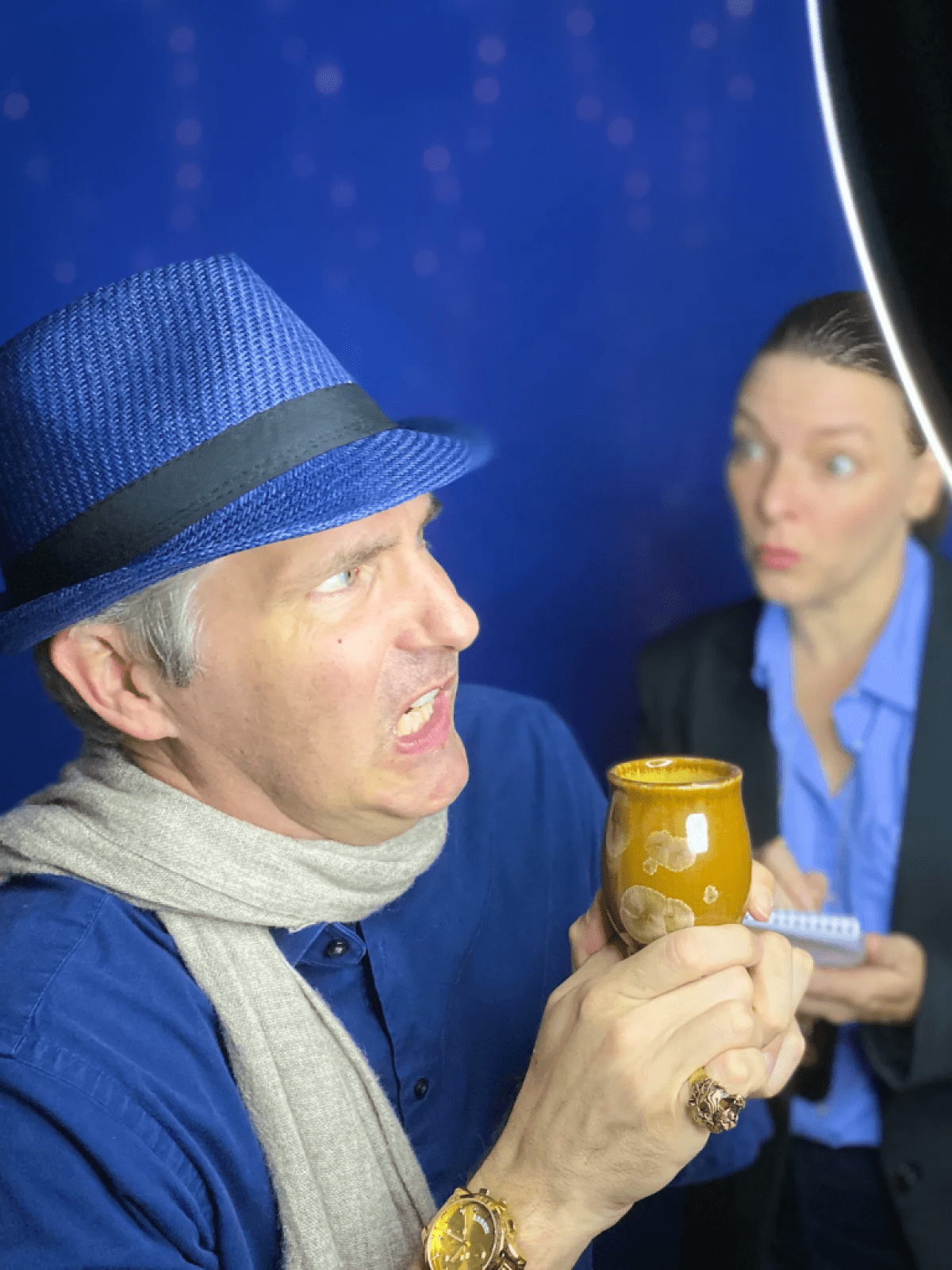 Man making a face at a woman whilst holding onto an object