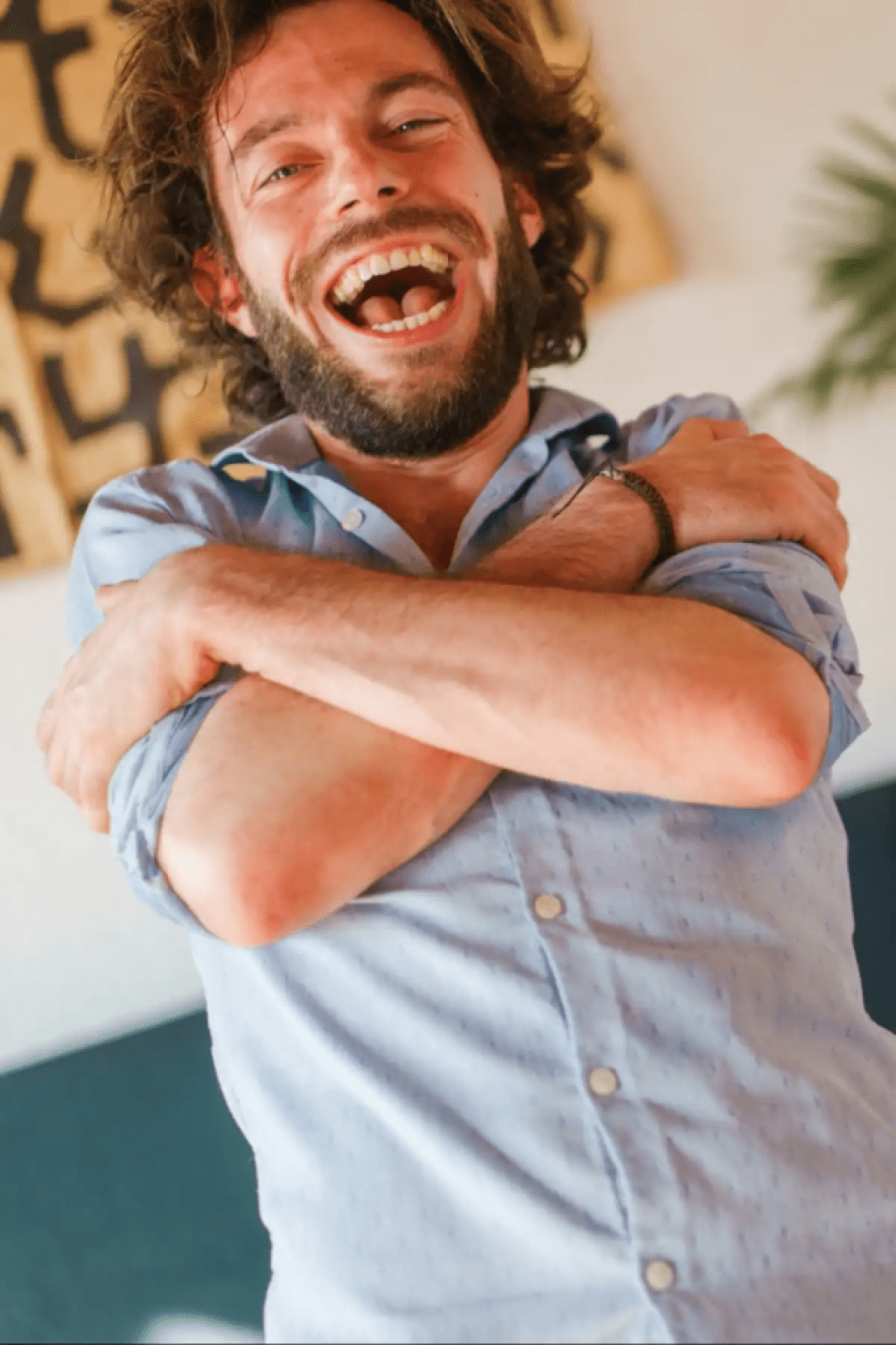 Man laughing while hugging himself