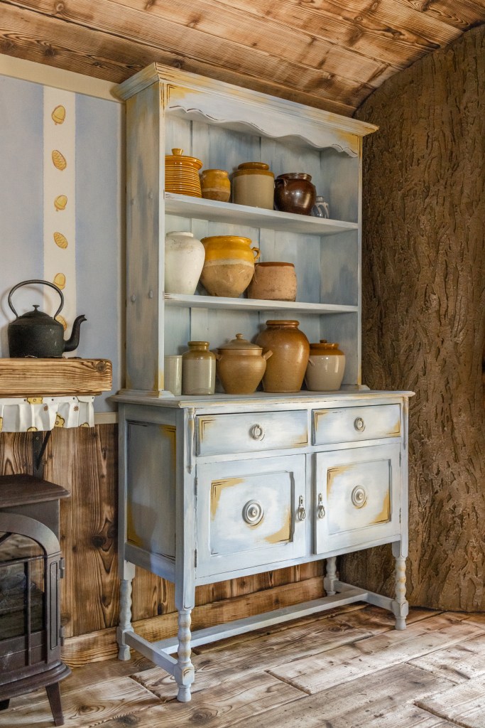 The specially commissioned kitchen dresser laden with honey pots.