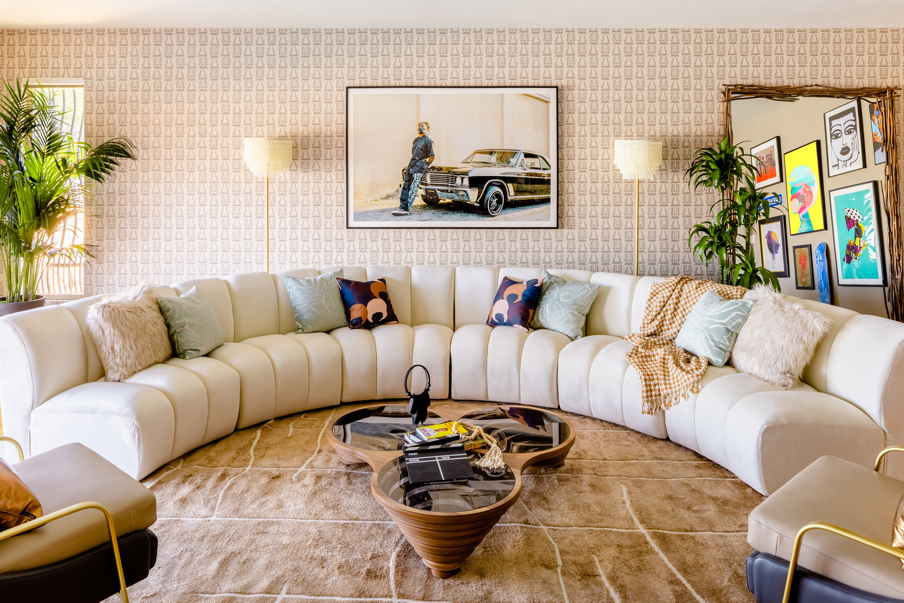 Neutral, cream colored living room with pops of color in dramatic art on the walls.