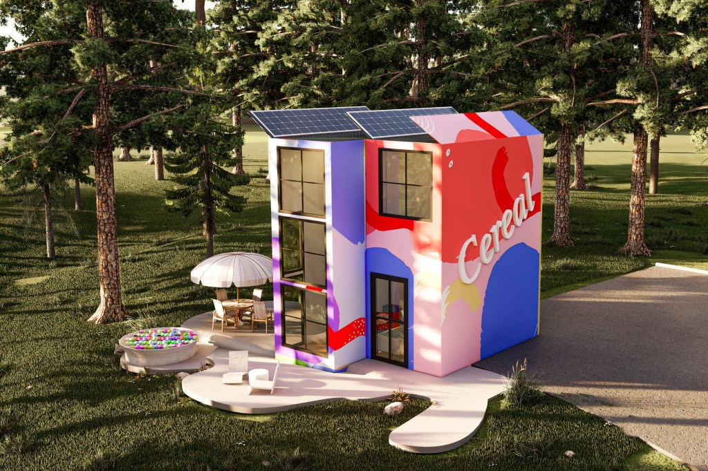 A colorful home with pinks, reds and blues and 'Cereal' written on the exterior wall, situated in the middle of the woods.