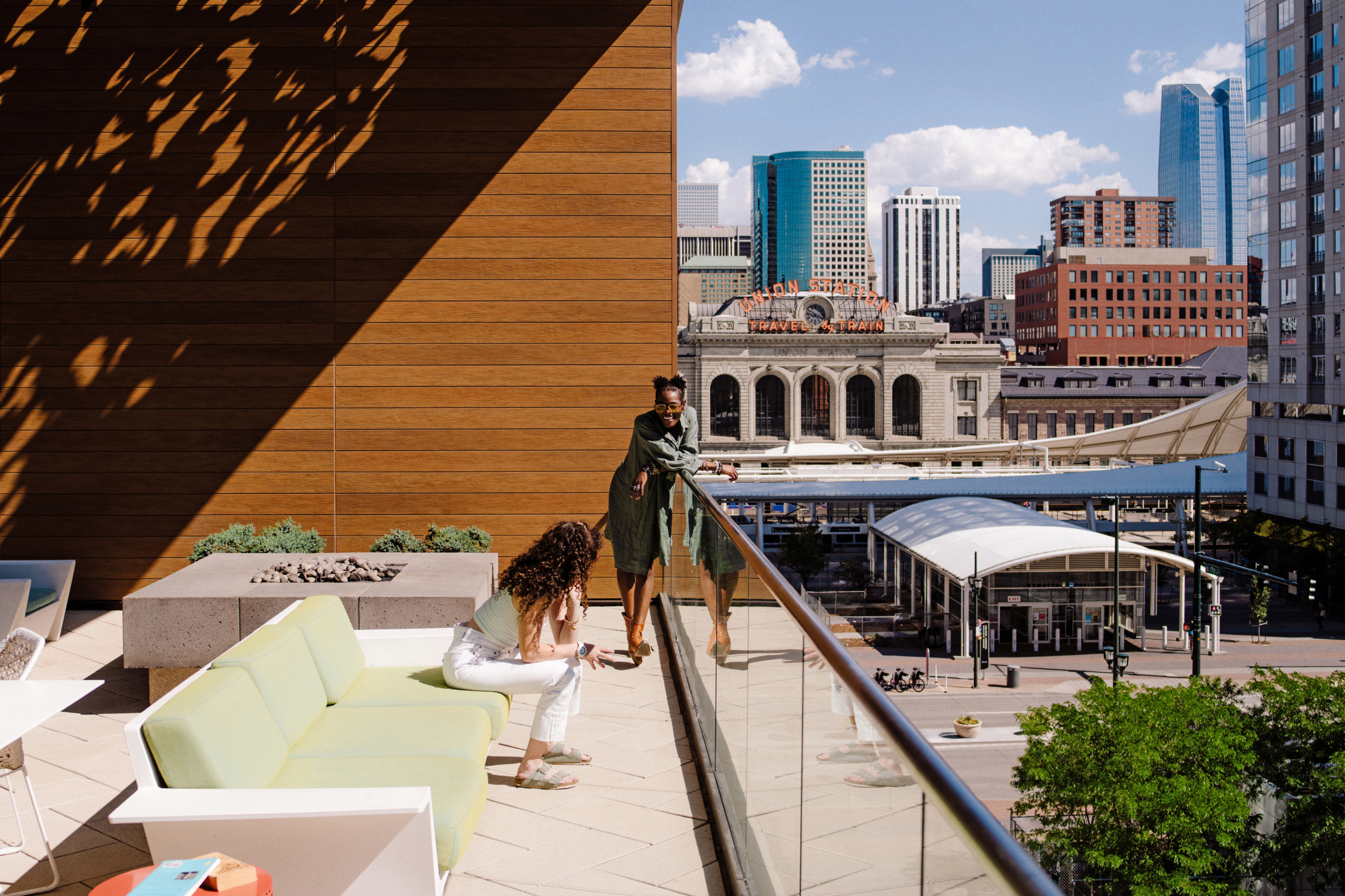 Two people lounge in outdoor apartment errce