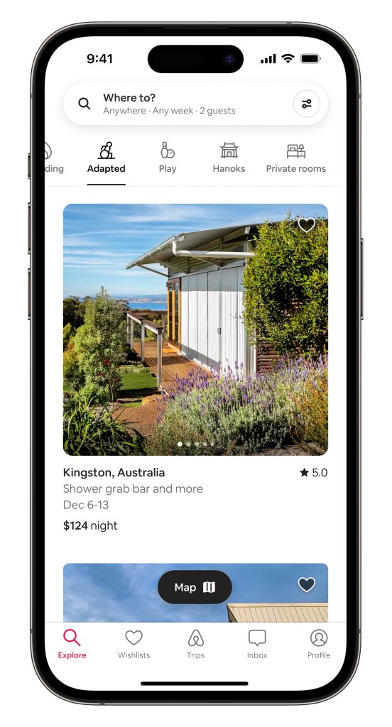 Airbnb Categories product in situ within an iPhone device showing the Adapted Category. The screen shows a one-story house in Kingston, Australia with a step-free entrance and vegetation surrounding it. A water view is in the backdrop.
