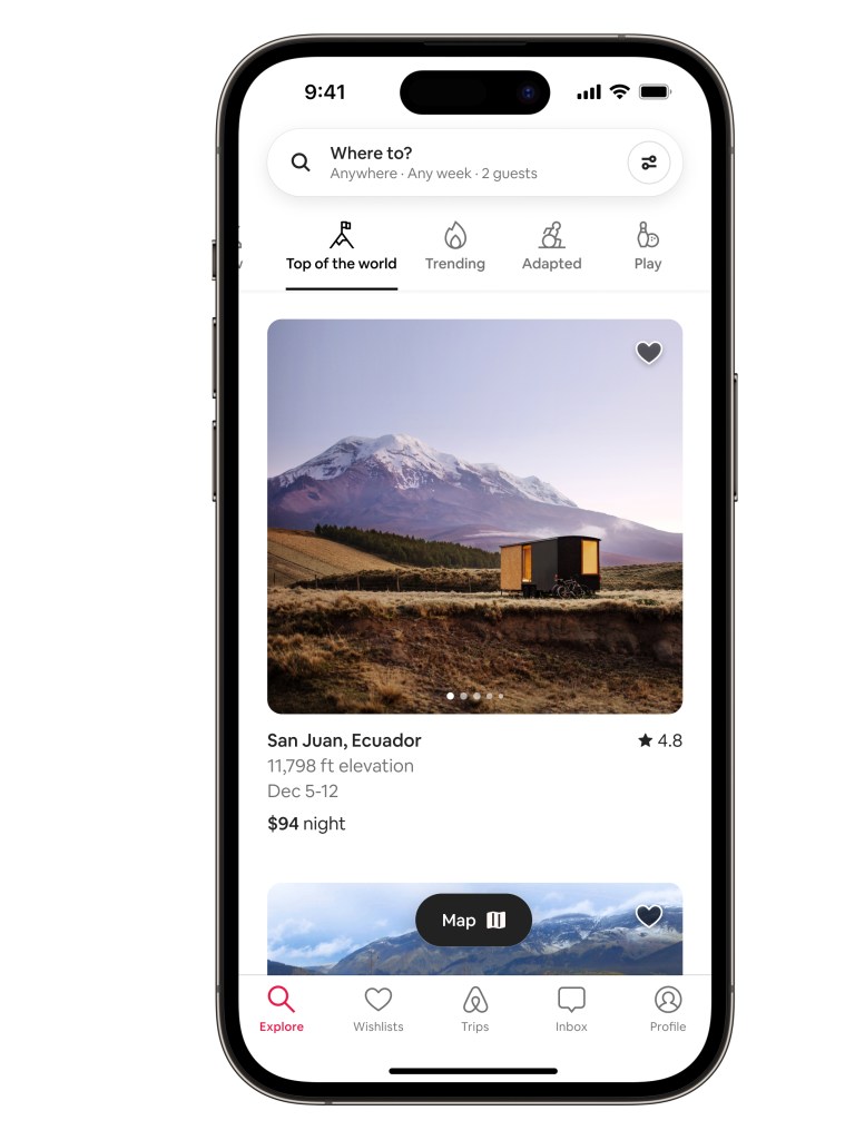 Airbnb Categories product in situ within an iPhone device showing the Top of the World Category. The screen shows a shipping container stay in a prairie with a mountain peak in the backdrop at dusk.