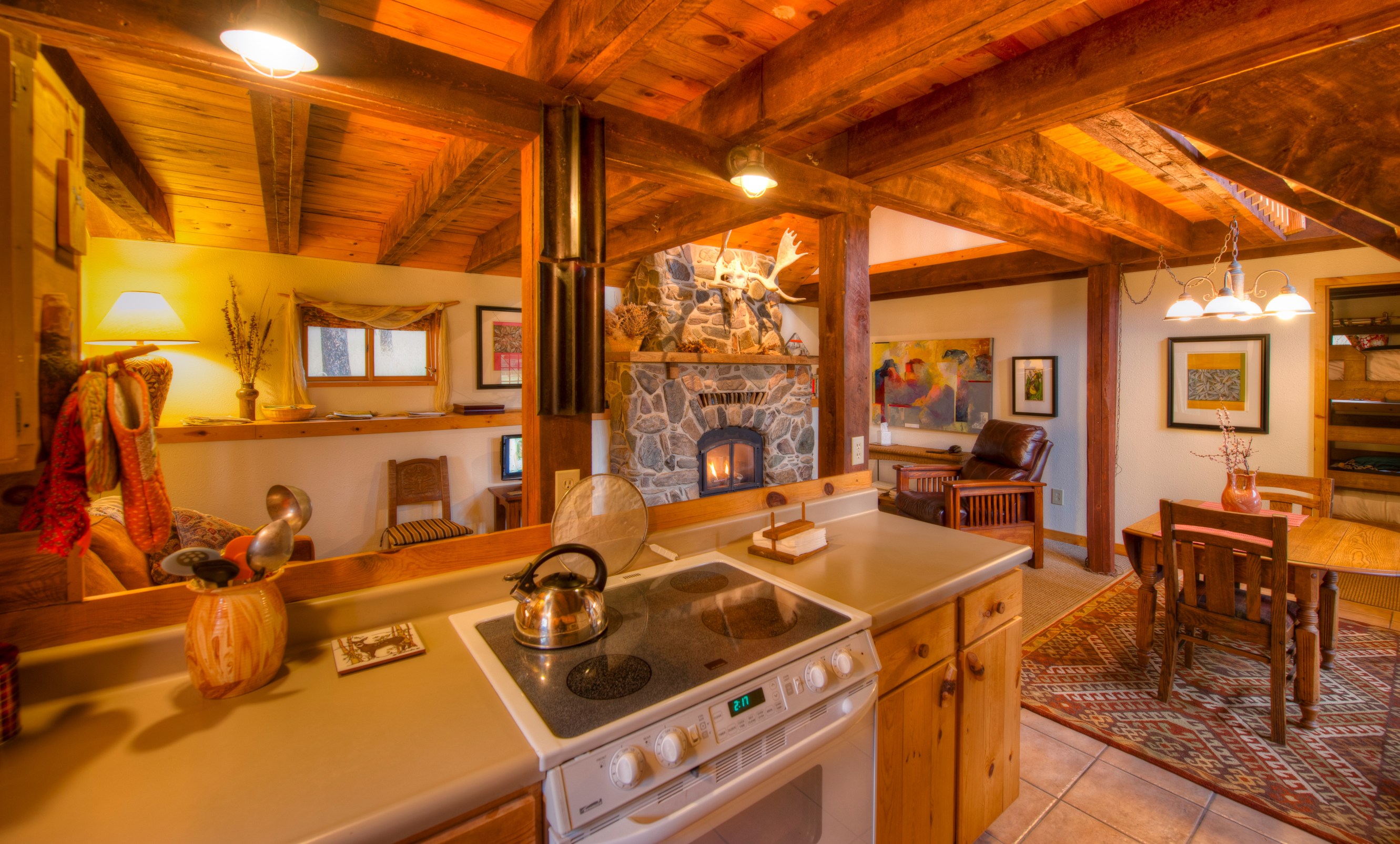 Kitchen with a table, cabin walls and an oven stove