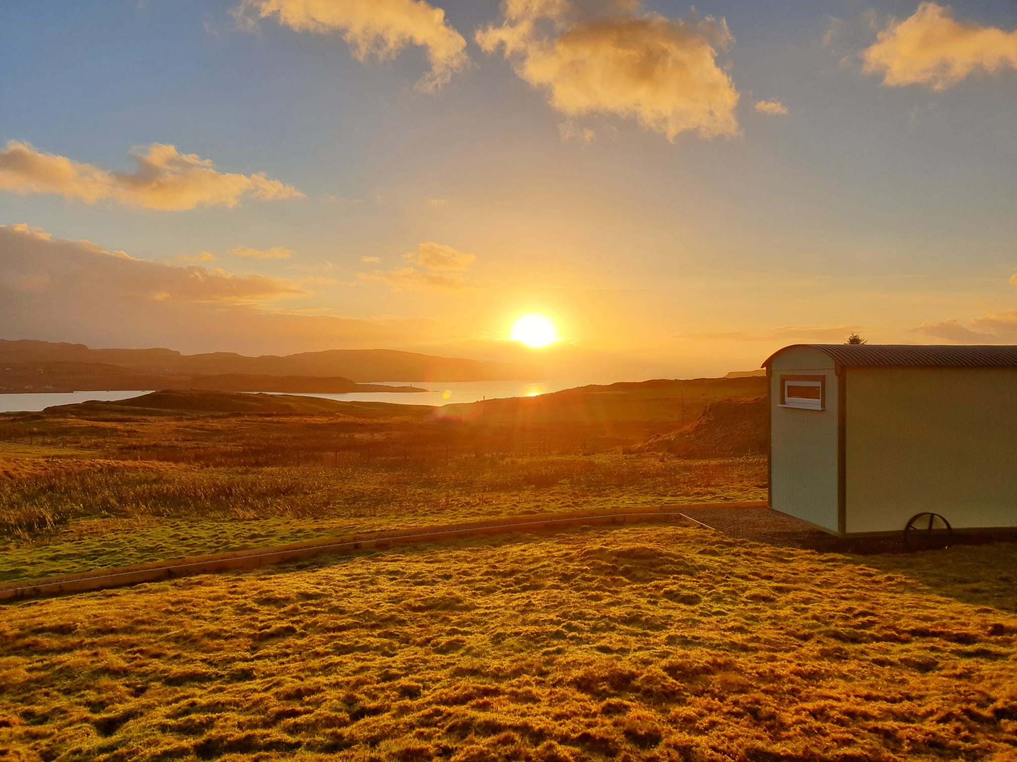 The caravan pictured on the hills, pictured in front of the setting sun
