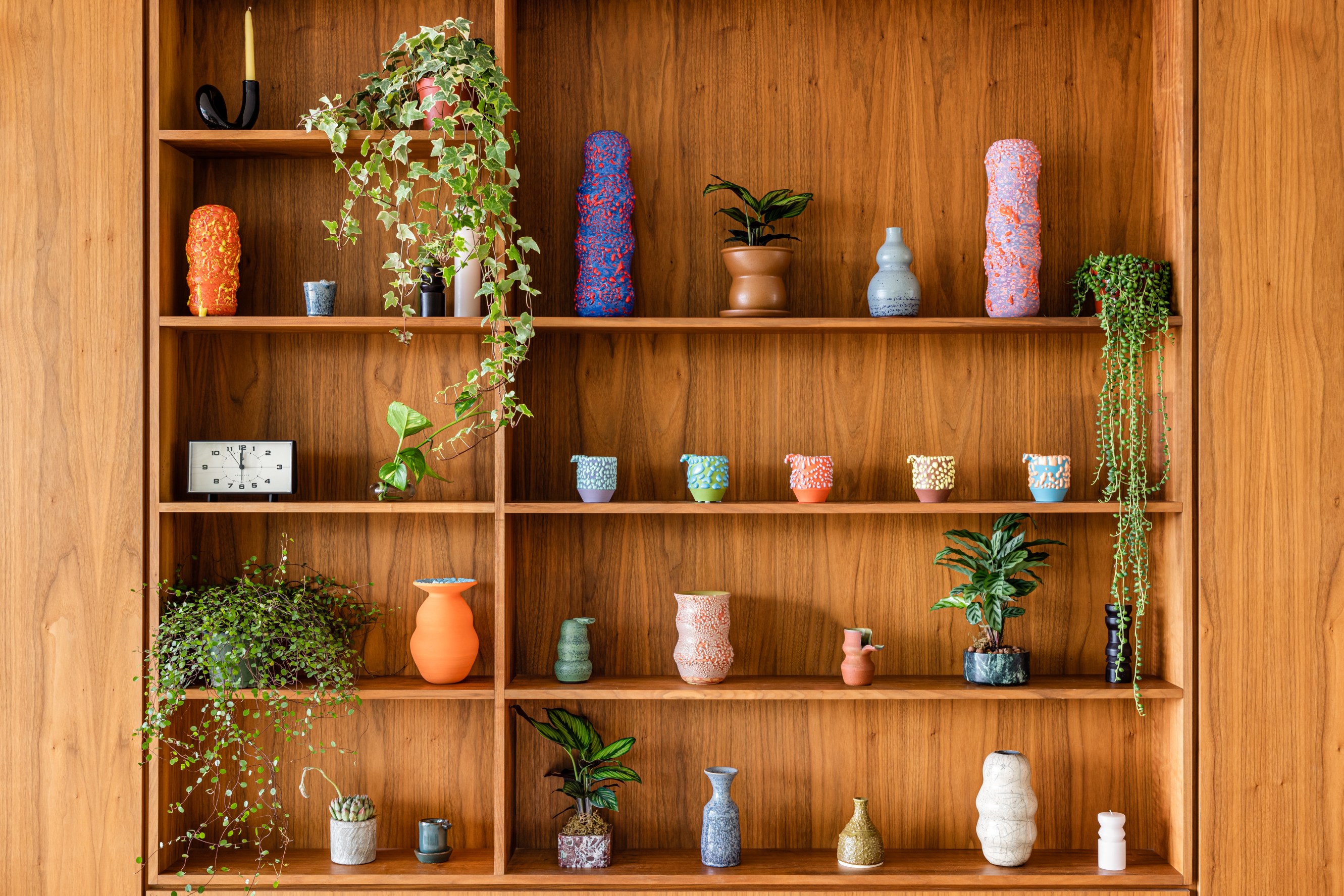 Close-up shot of the pottery wall, which includes a variety of vases of different colors and textures.