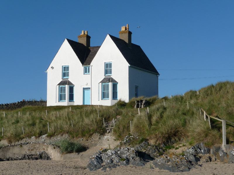 A white home located on the English coastline, a part of the most wishlisted New homes for UK travellers