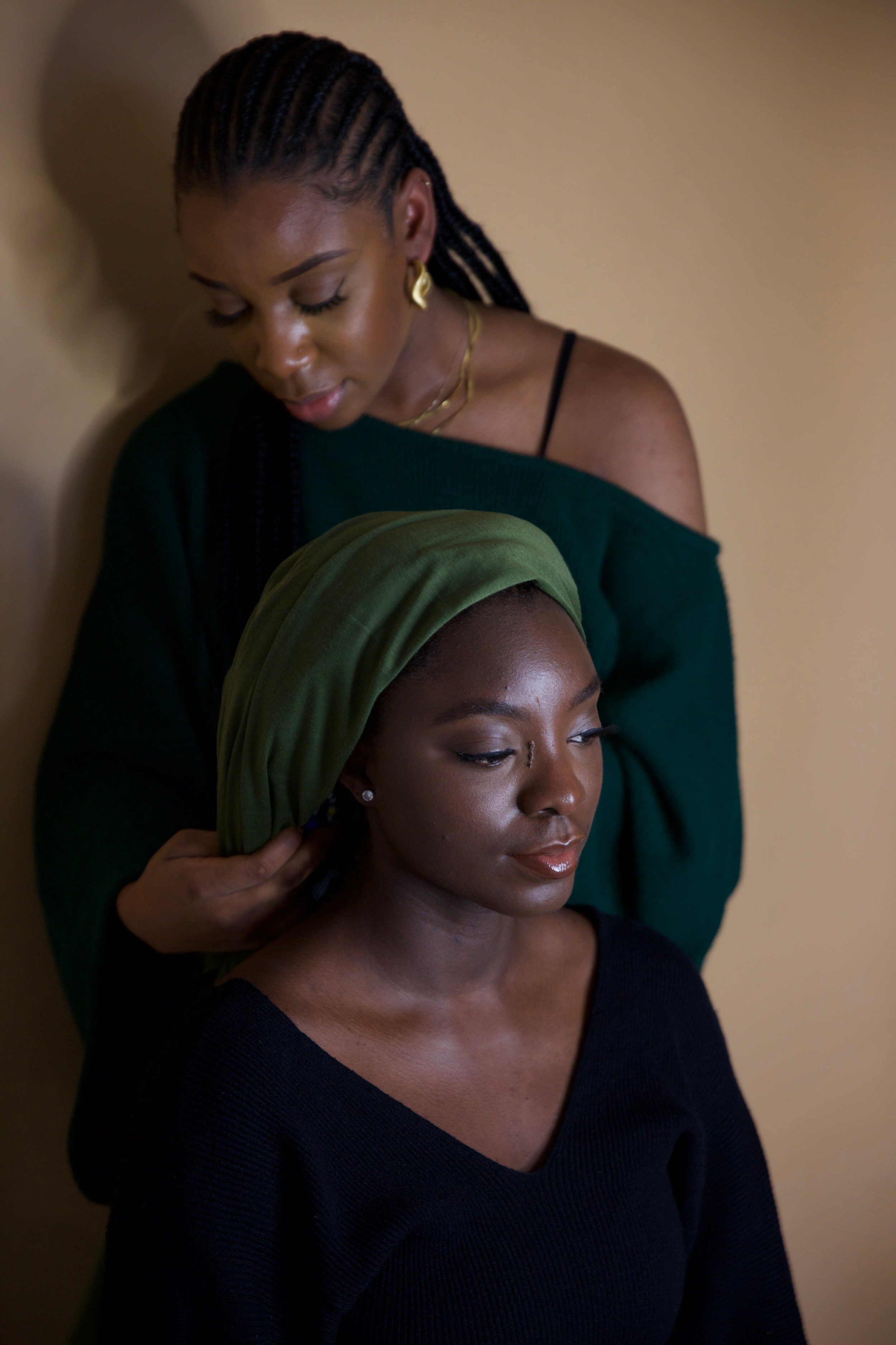 A woman has her hair wrapped in a traditional scarf for Afro hair