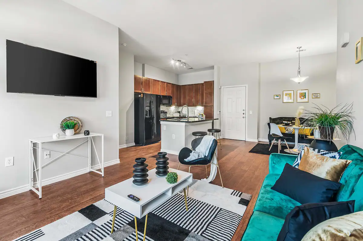 Image depicting living area with a couch and tv in affordable Houston Airbnb