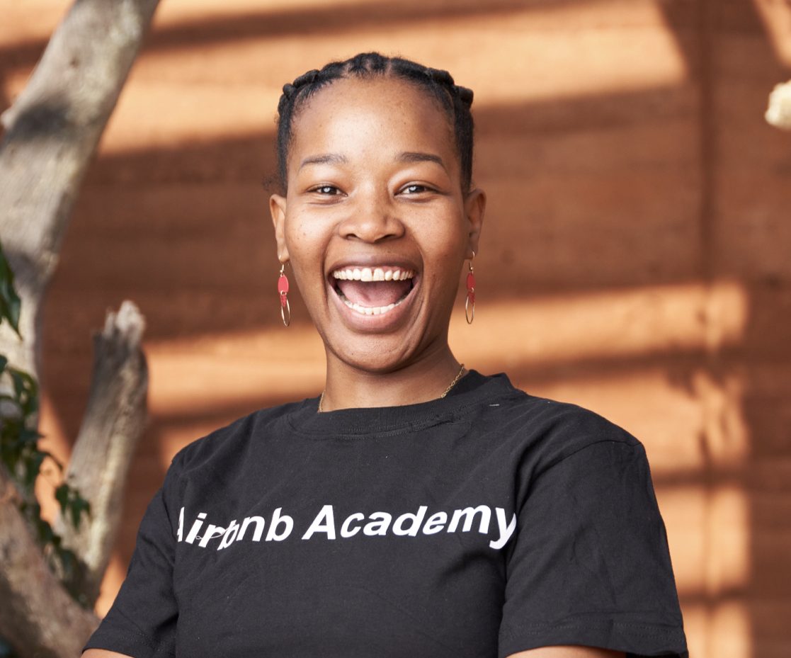 Woman smiling in Airbnb Academy t-shirt