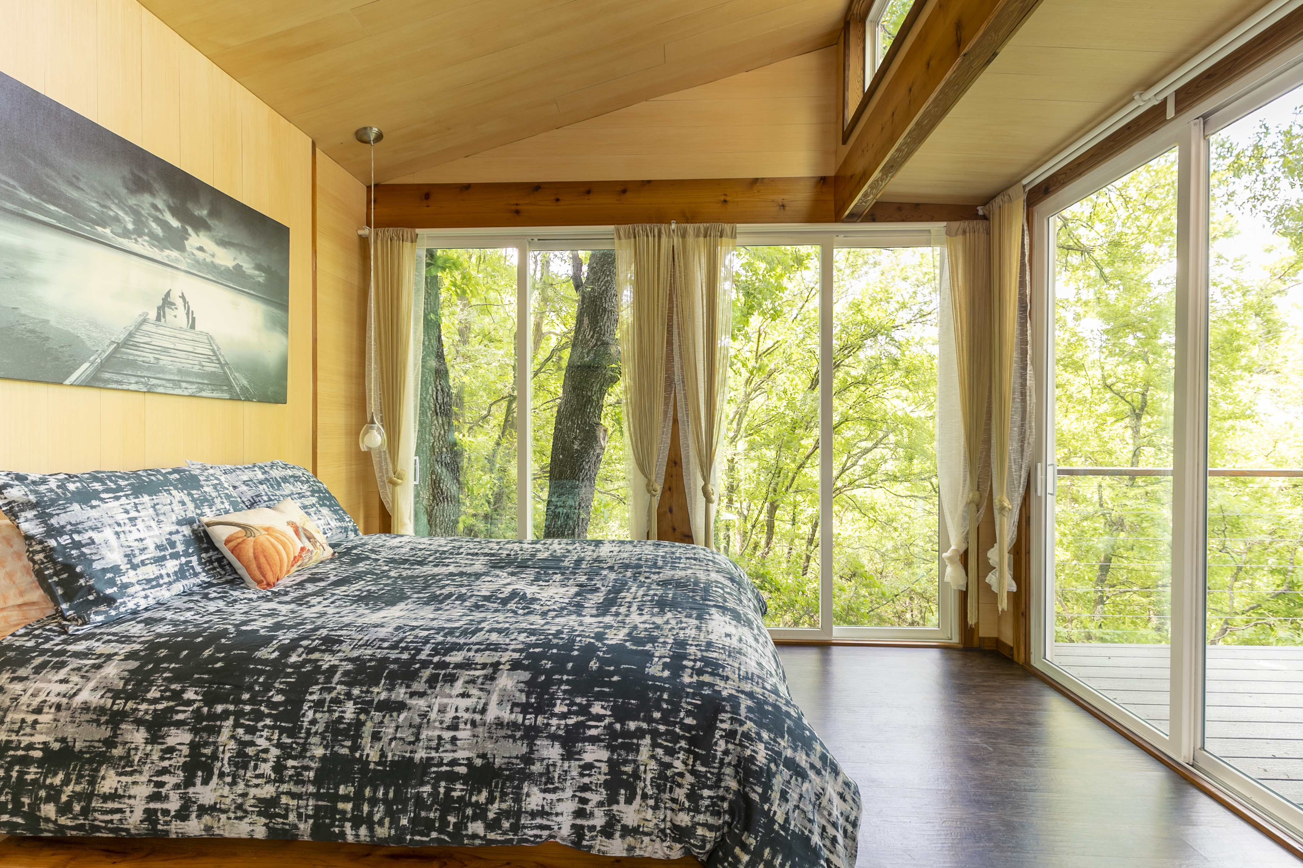 Image of a bedroom among the treetops in a treehouse listing