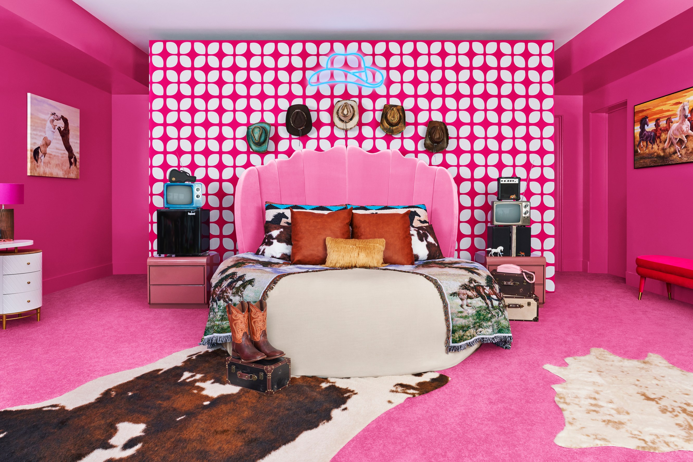 Interior of Ken's bedroom, mostly pink, accented by animal print rugs and cowboy hats.