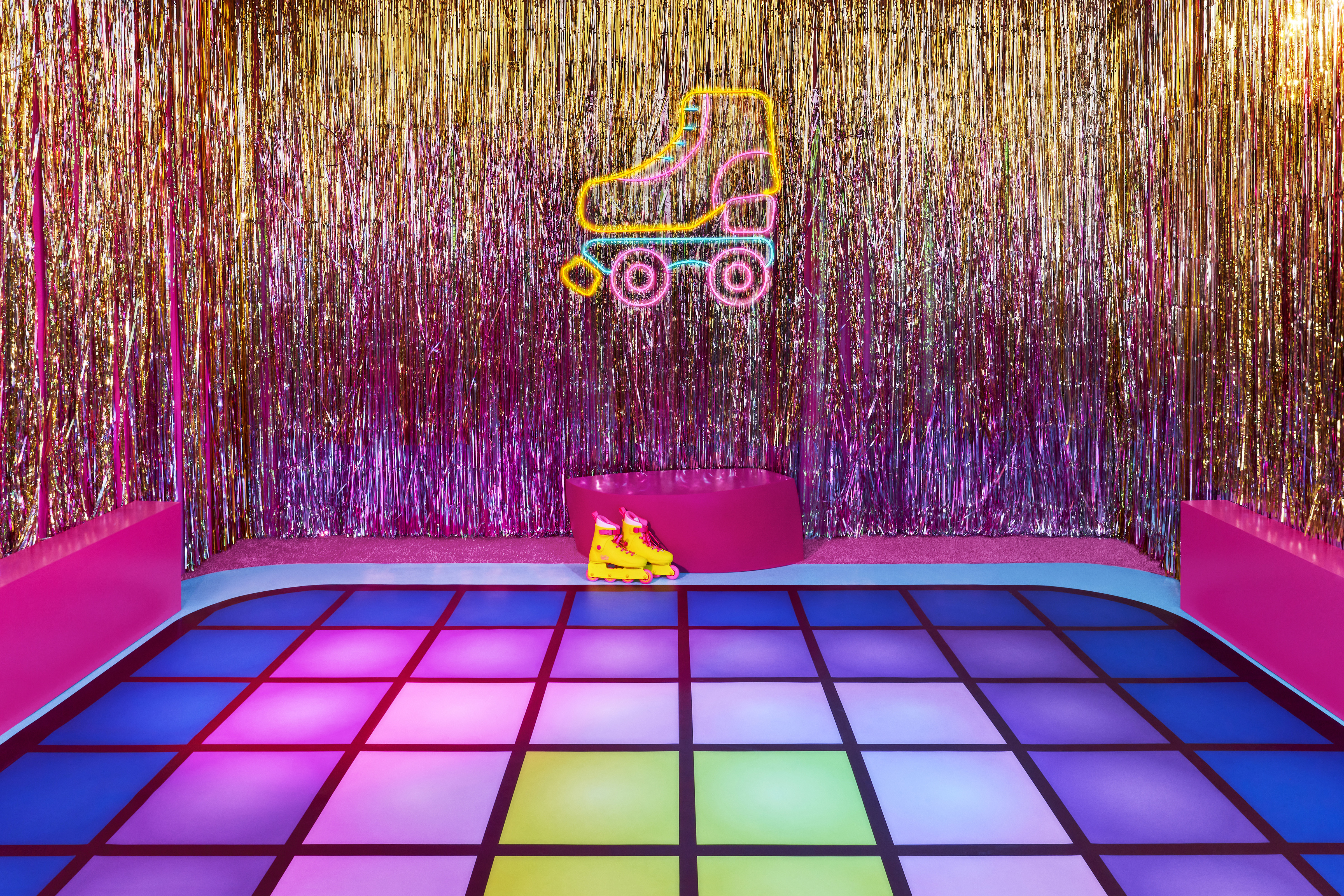 Rainbow colored roller rink with glittery streamers against the wall.