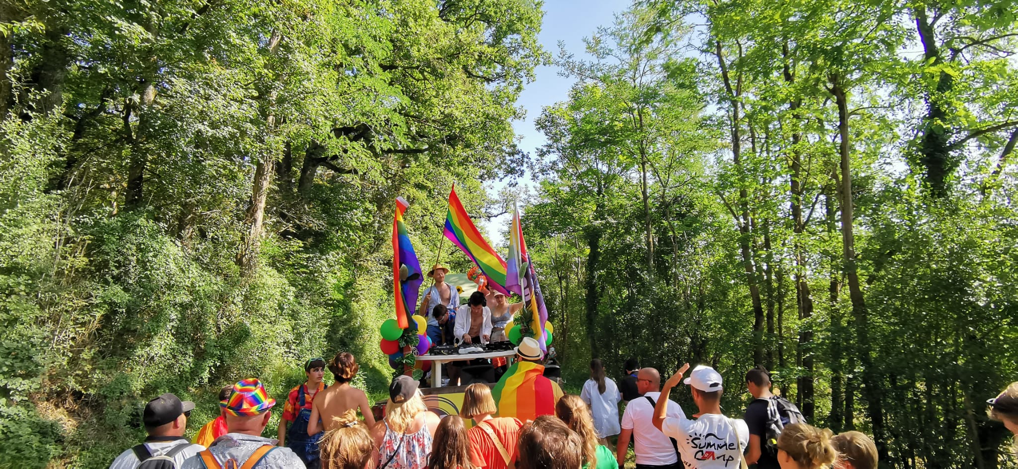 Crowd with Pride flags at rural pride event in France