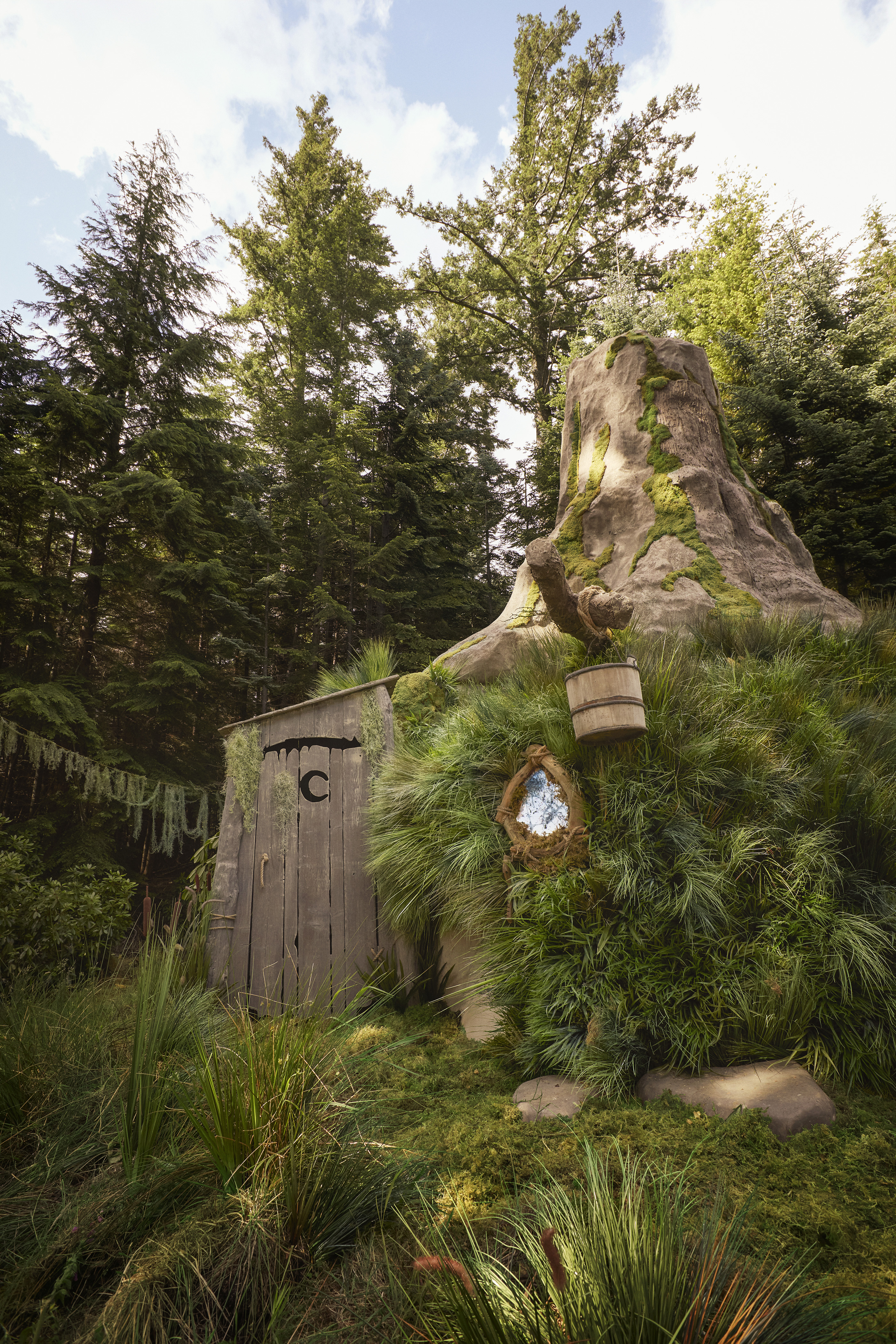 Exterior view of Shrek's Swamp showing the outhouse adjoining the stump