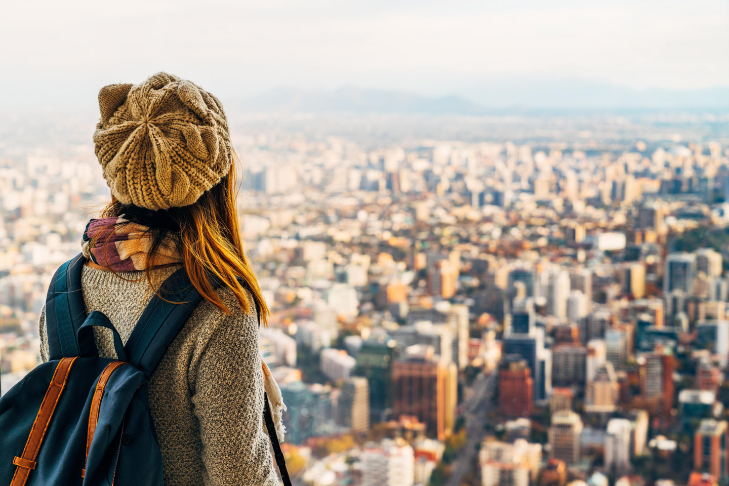 Woman with a hat looking at Santiago, Chile