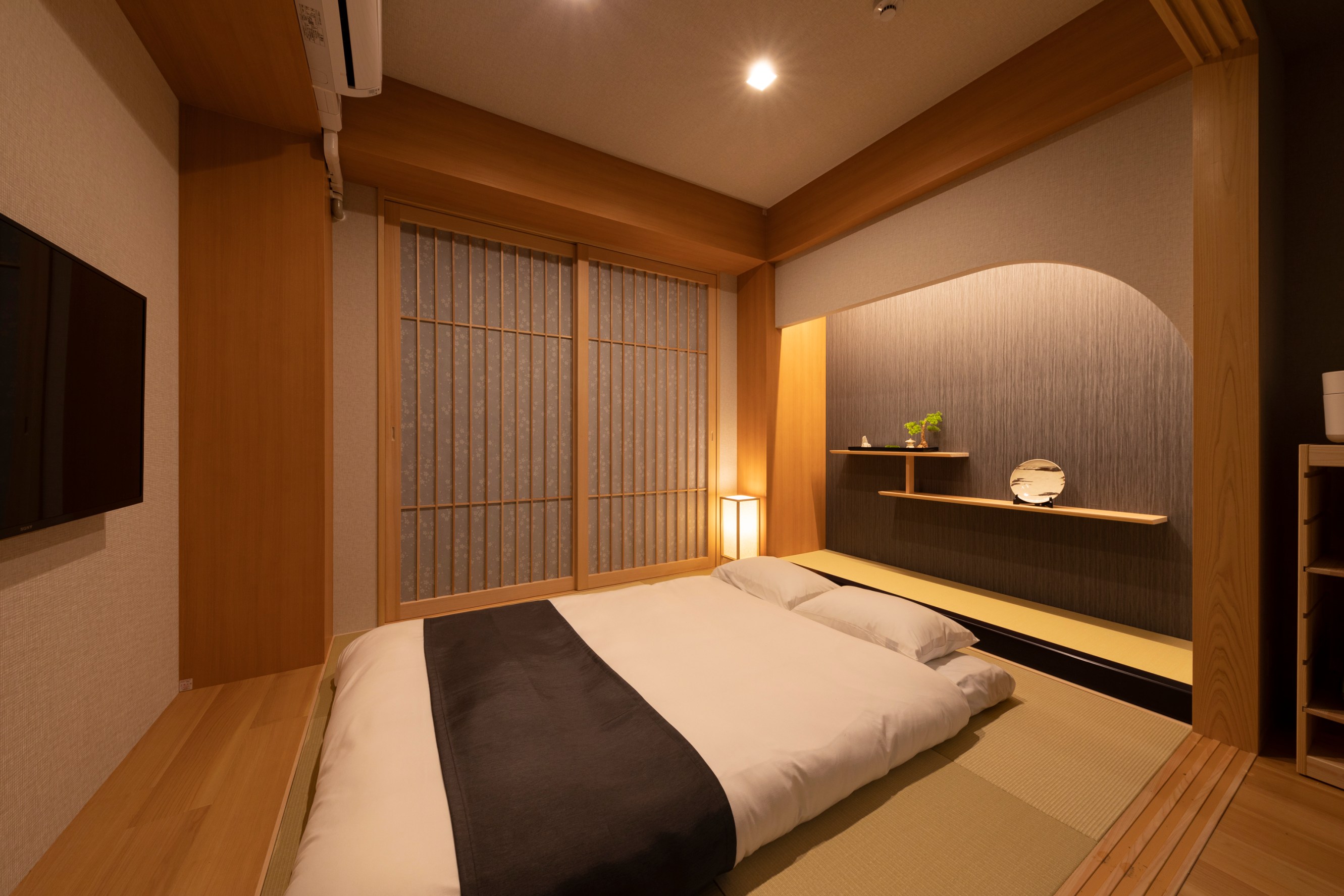 A dimly lit wood paneled bedroom